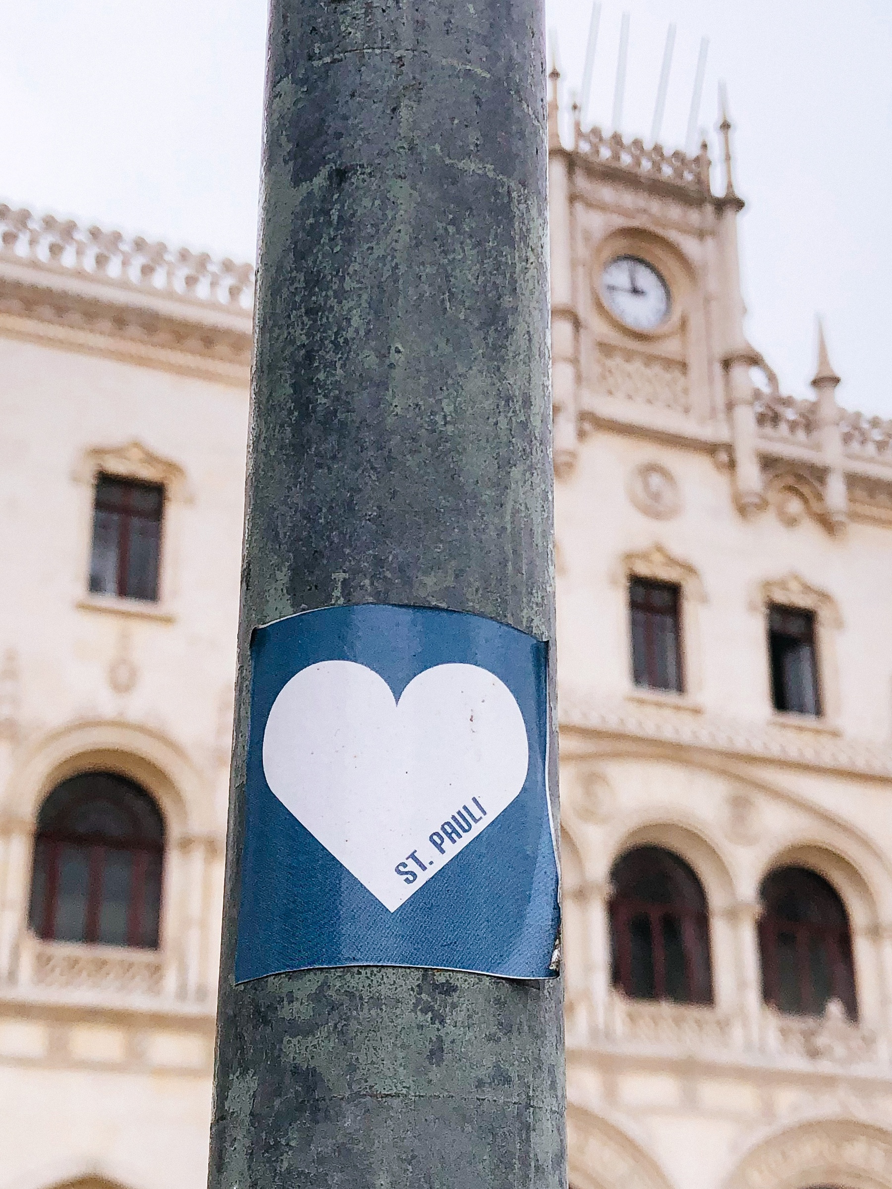 Sticker of a heart with the words “St. Pauli”, and a cool classic building in the background.  