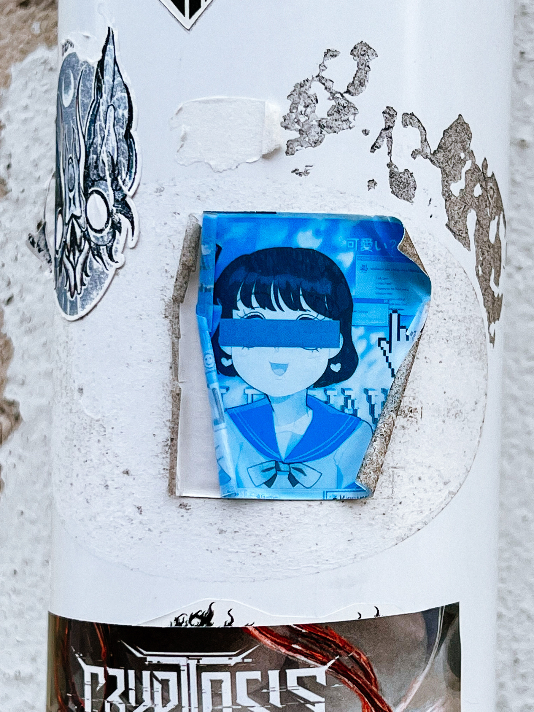 Sticker of an anime girl, with an anonymity strip over her eyes. In blue. 