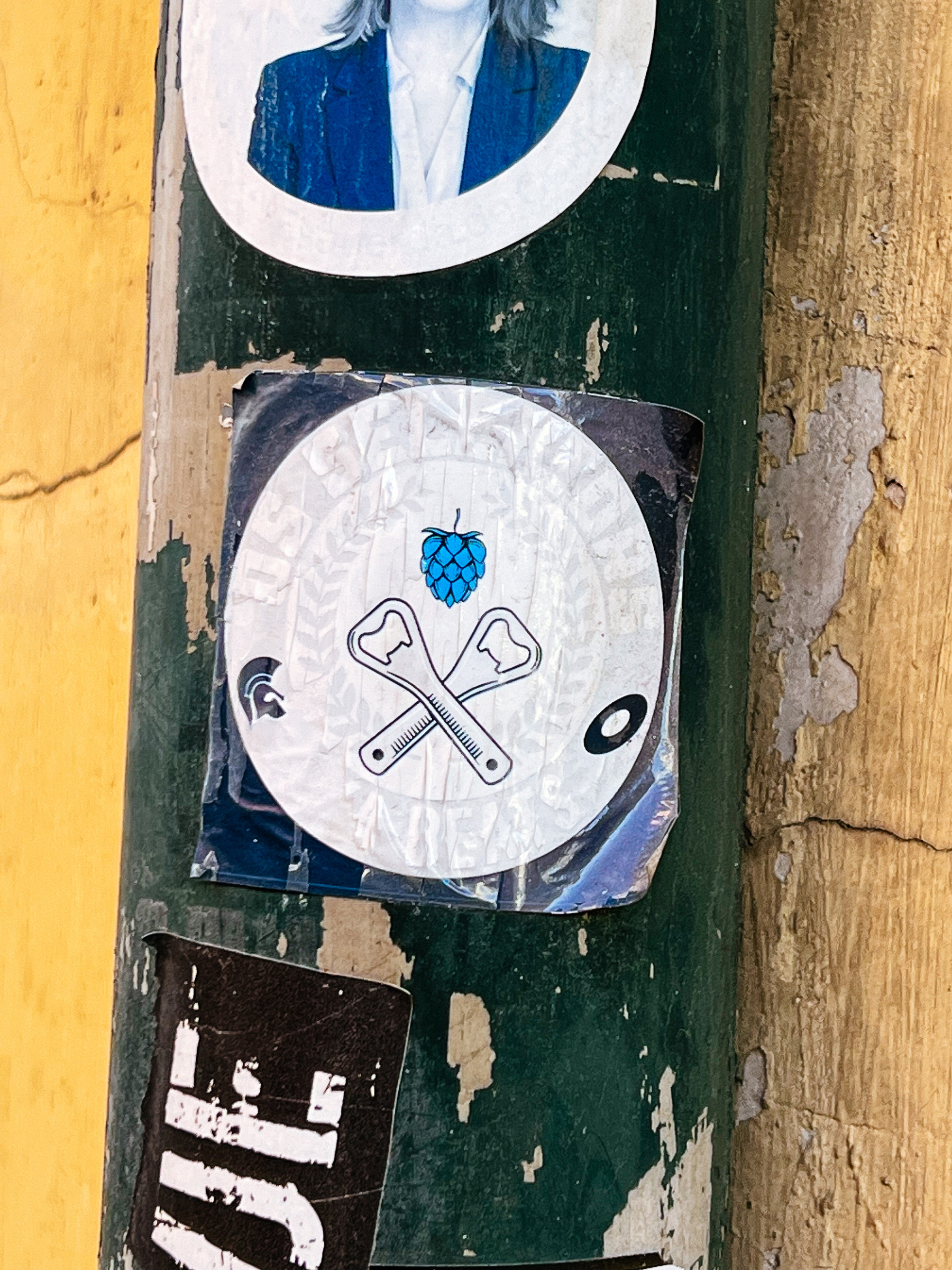 Sticker with a two crossed bottle cap openers, and a hop. 