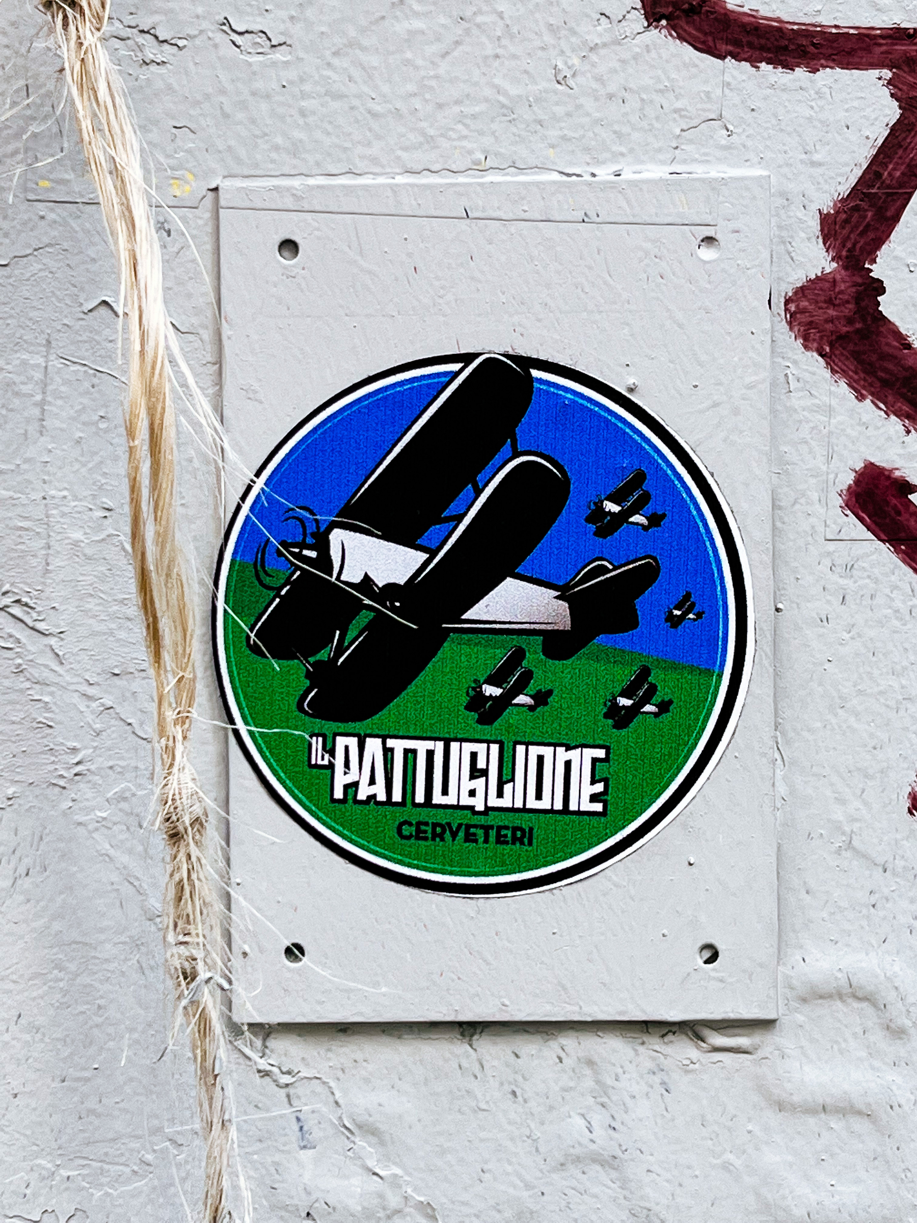 Sticker for “Pattuglione” brewery, with a bunch of vintage airplanes flying through the sky. 