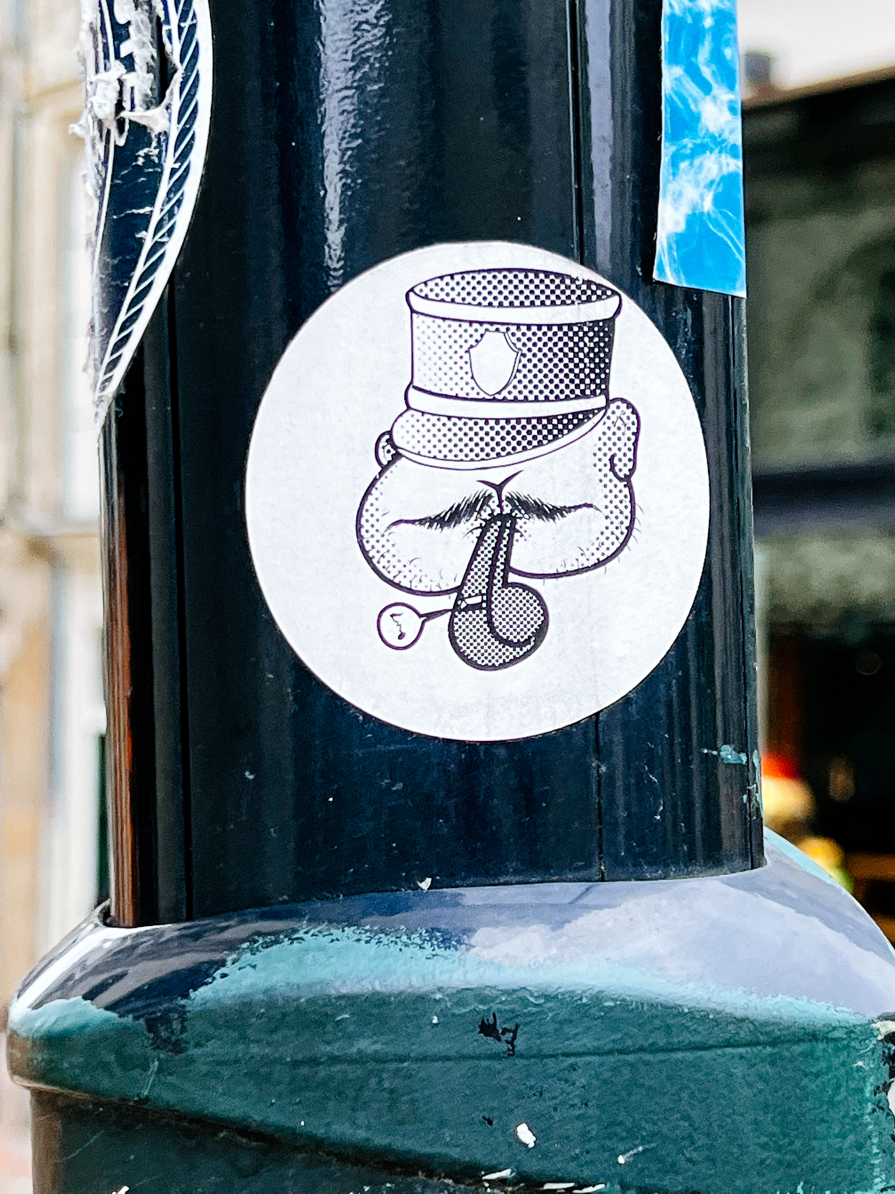 Sticker of what looks like a butt with a policemen’s cap, and a whistle in his “mouth”. 