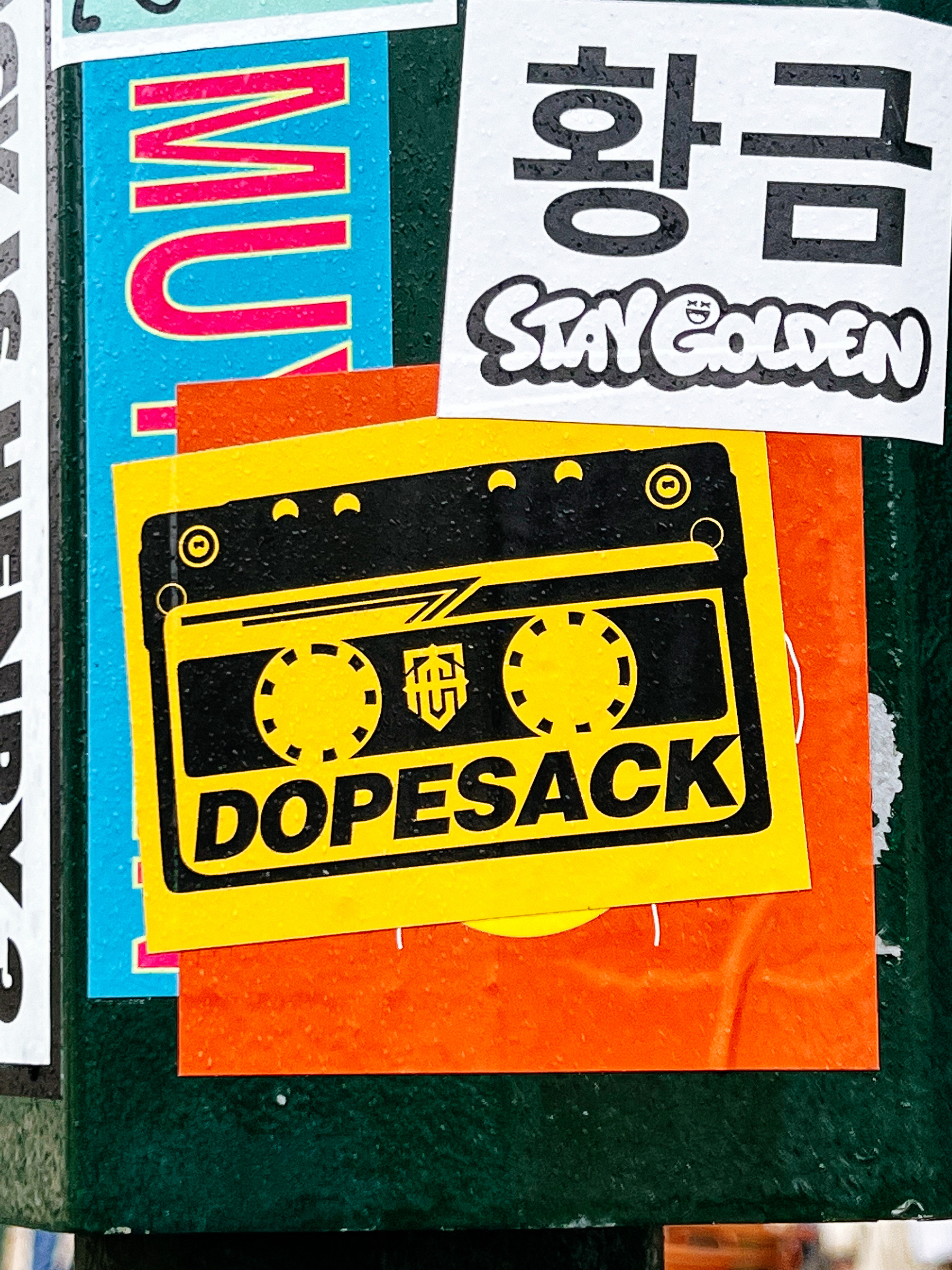 Sticker of a yellow cassette, with the word “dopesack”. 