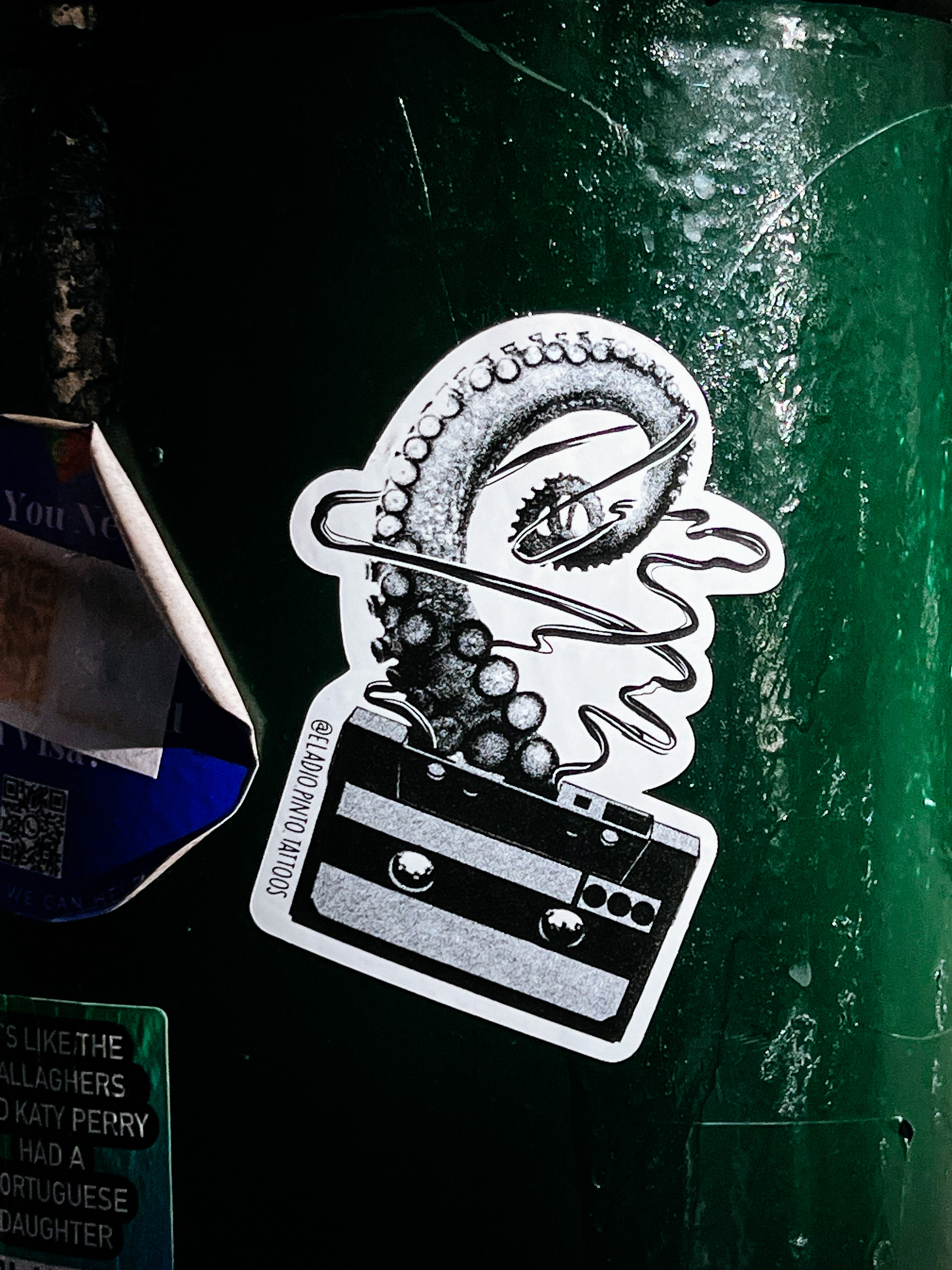 Sticker with a montage design, a vintage cassette with an octopus tentacle coming out of it. 