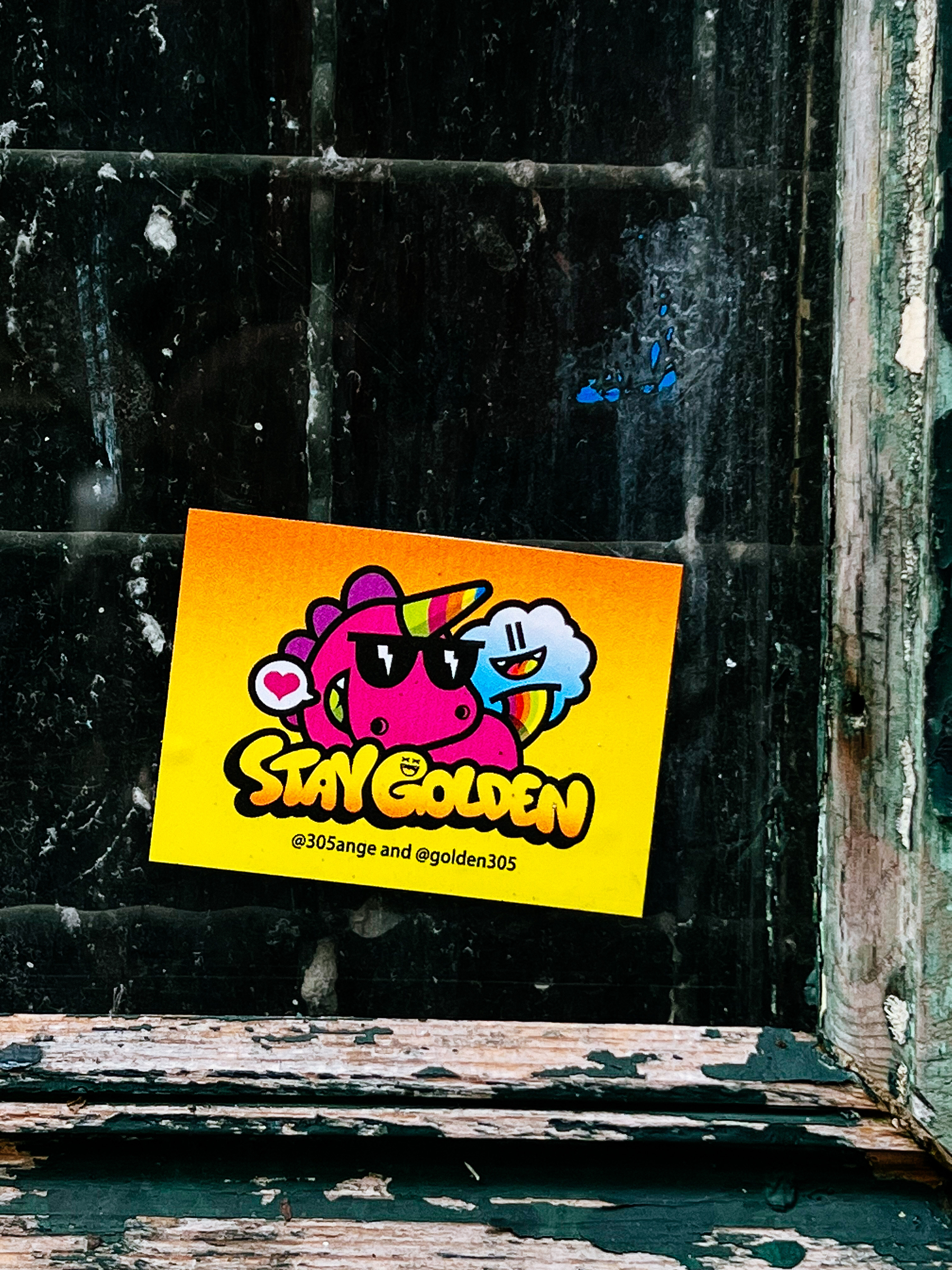 Sticker with a pink unicorn, with rainbow horn, and the words “Stay Golden”. 