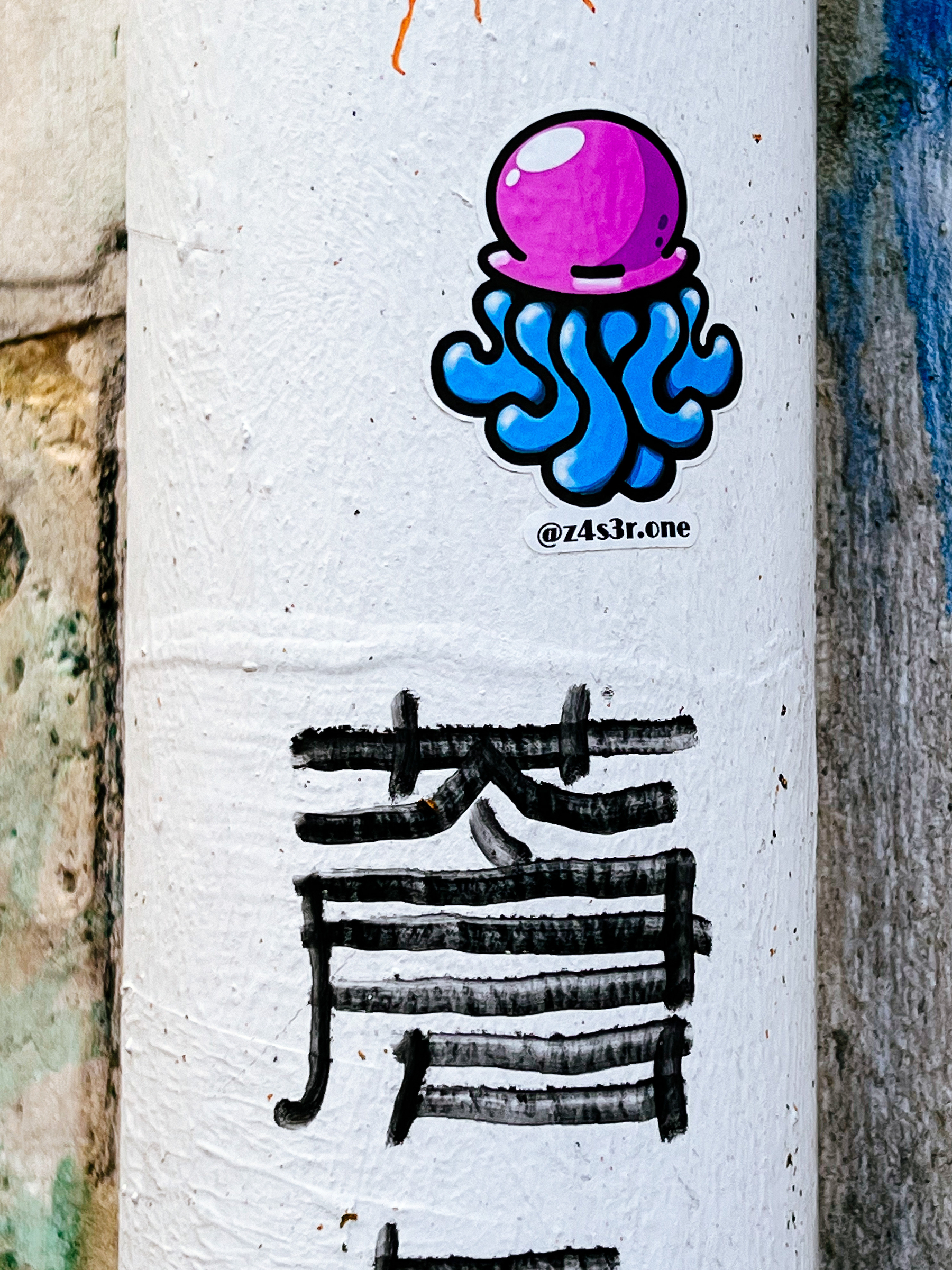 Sticker of a pink squid/octopus-like creature, with blue legs. 