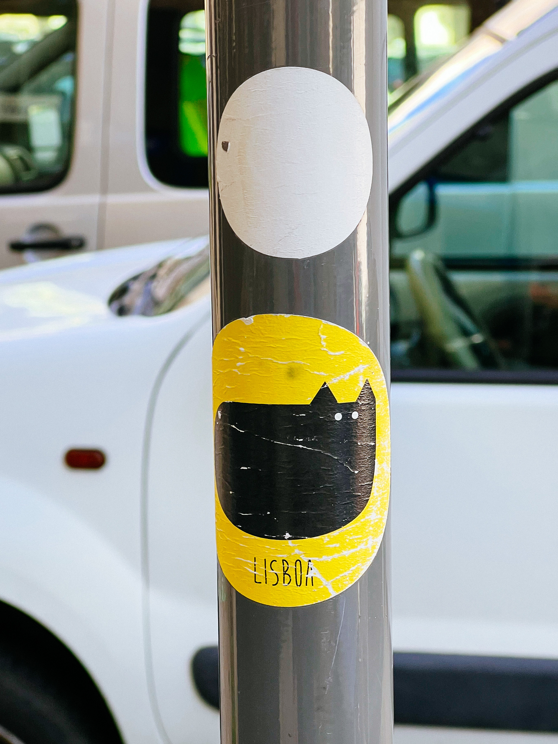 Sticker of a fat black cat with the word “Lisbon”
