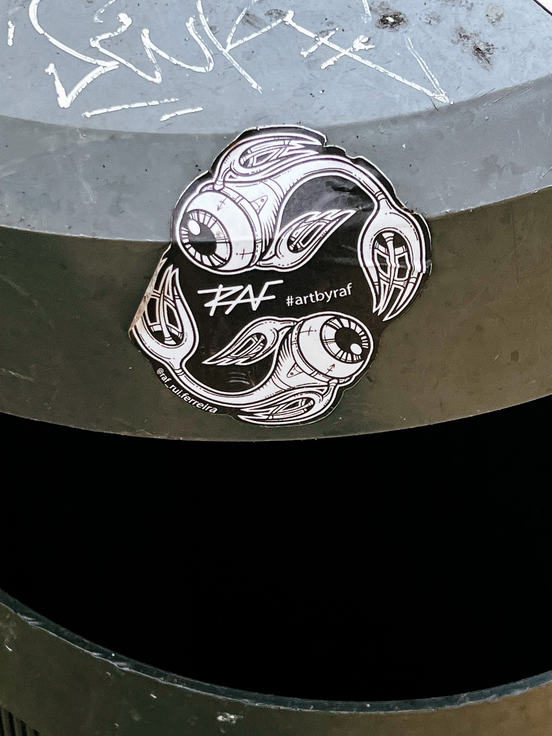 Sticker with some sort of “mechanical” creatures, with eyes on the front. 