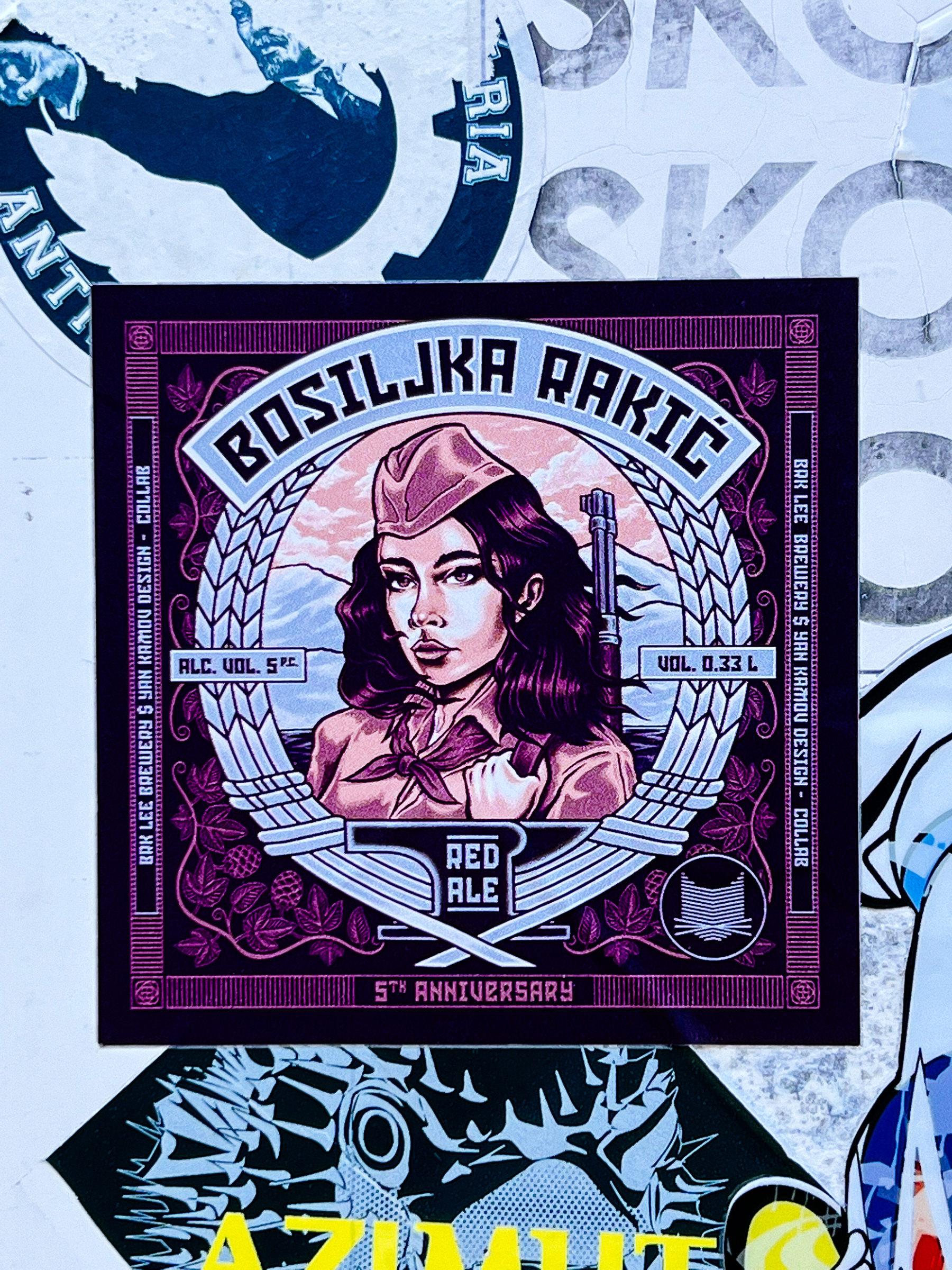 Sticker of a beer brand, with an illustration of what looks like a vintage Soviet (?) woman fighter, with a rifle hanging from her shoulder. 