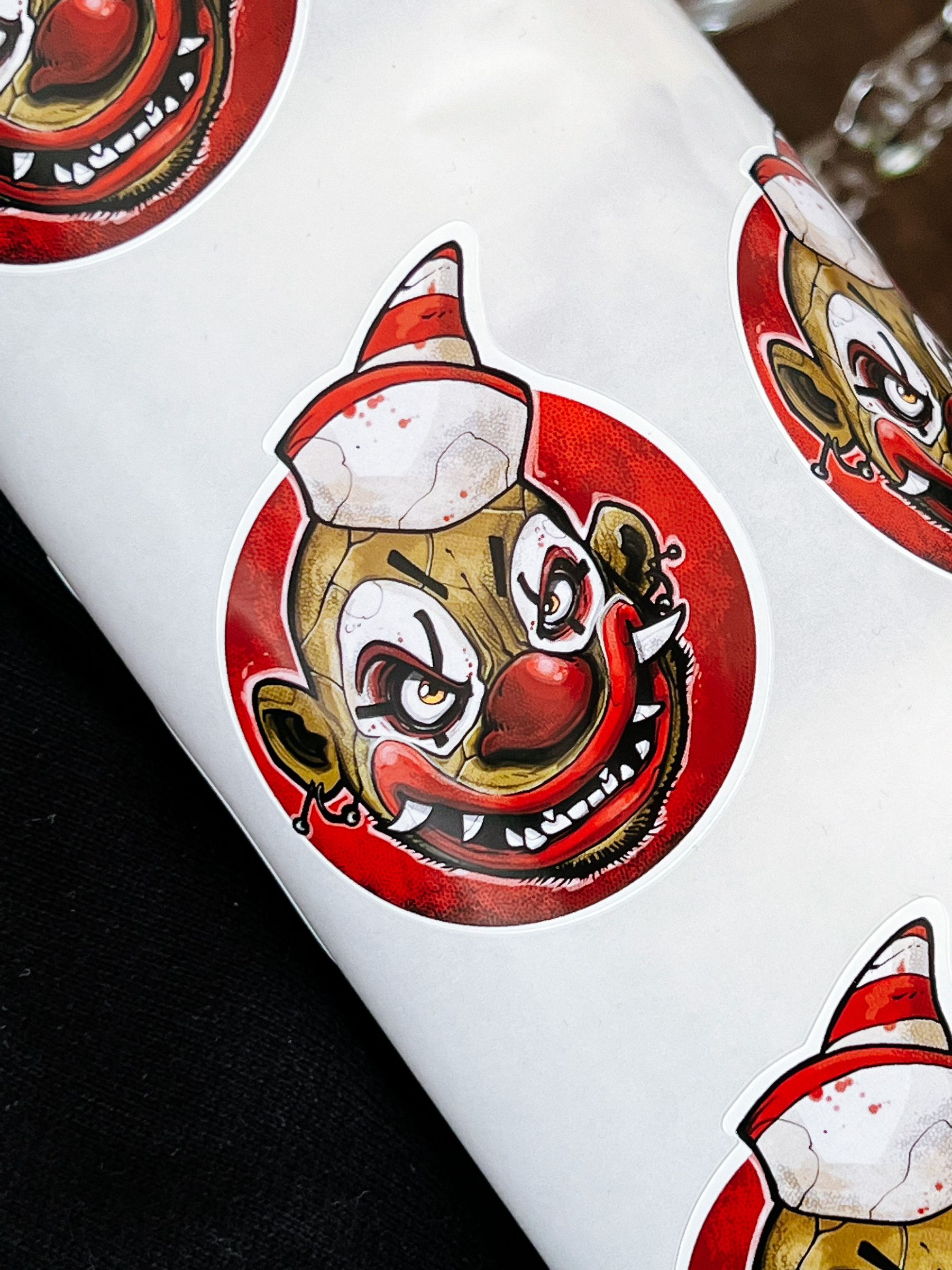 A roll of stickers with a very menacing clown. 