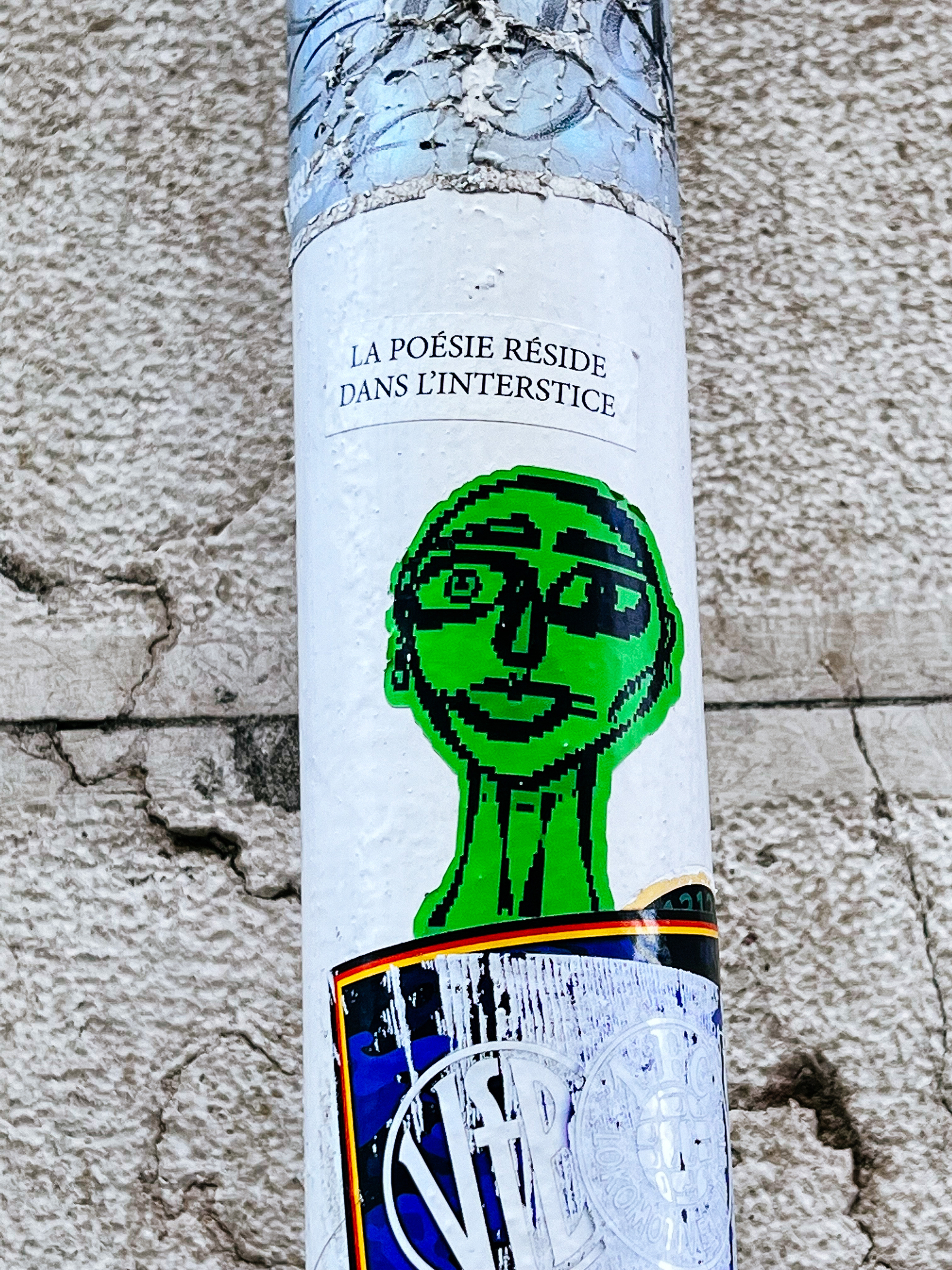 Sticker of a pixelated face, meme-like, in green. 