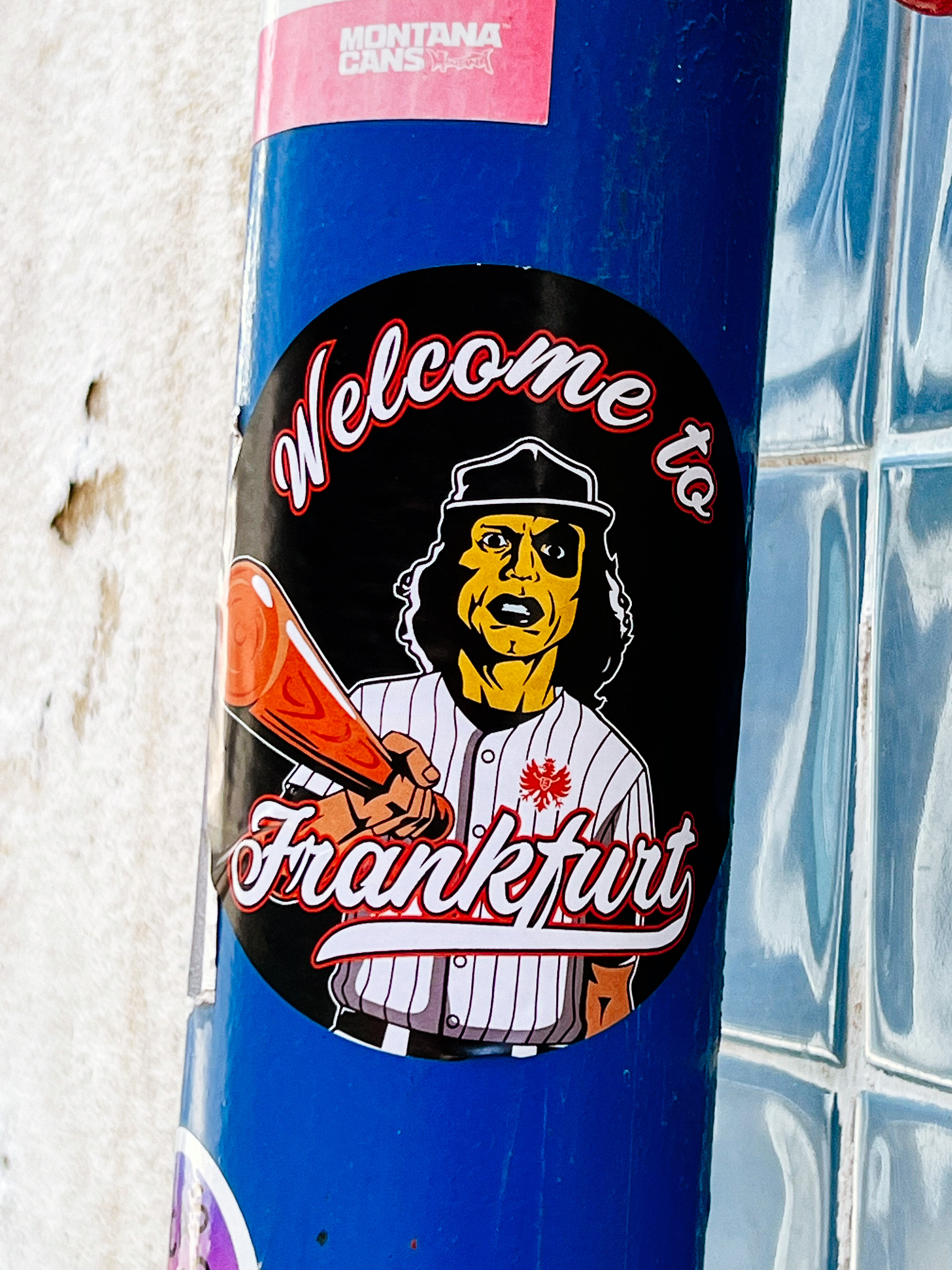 Sticker with a zombie-like baseball player, menacing looking, and the words “welcome to Frankfurt”. 