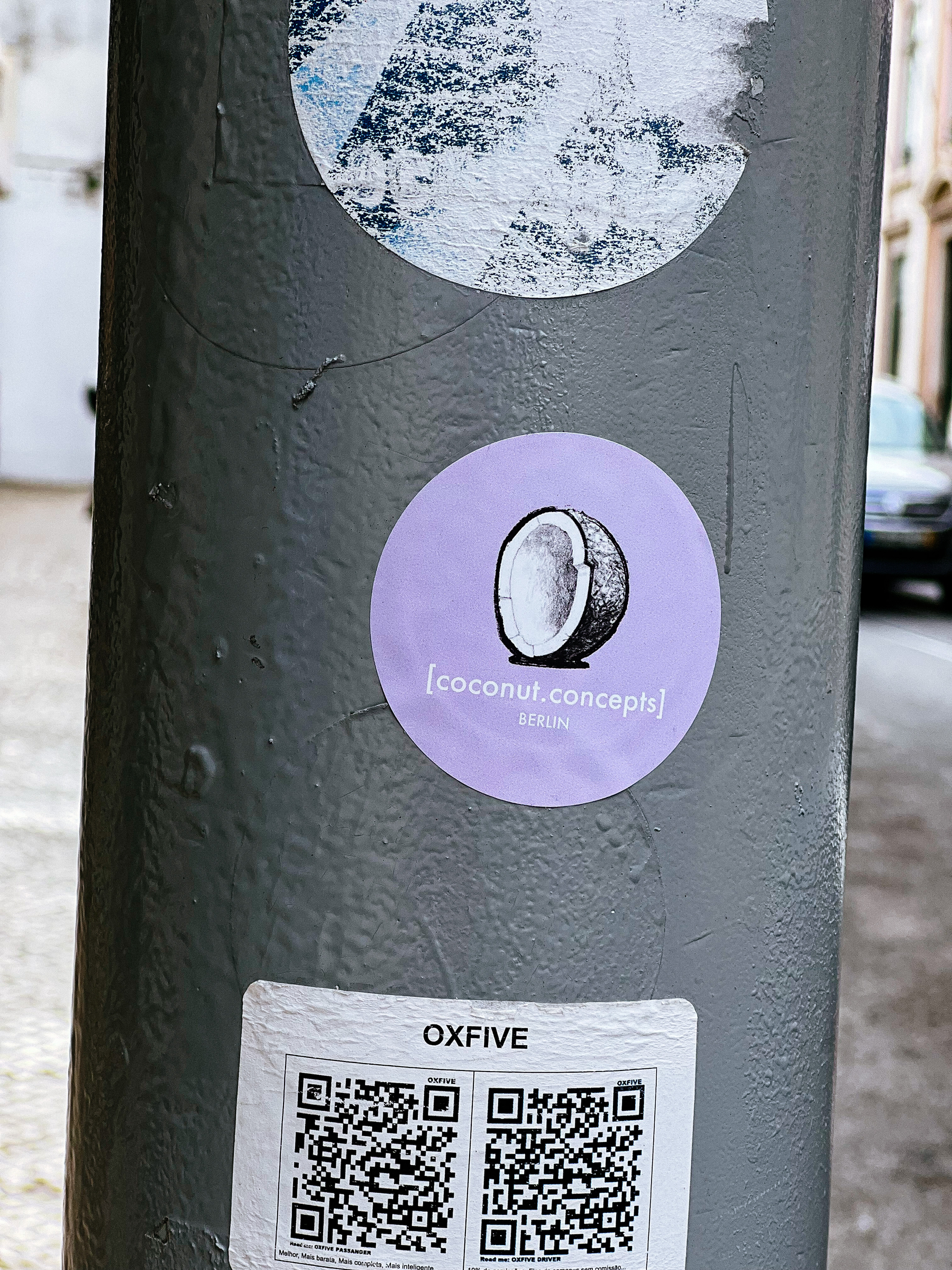Purple sticker, with the drawing of half a coconut, and the words “Coconut concepts / Berlin” written on it. 