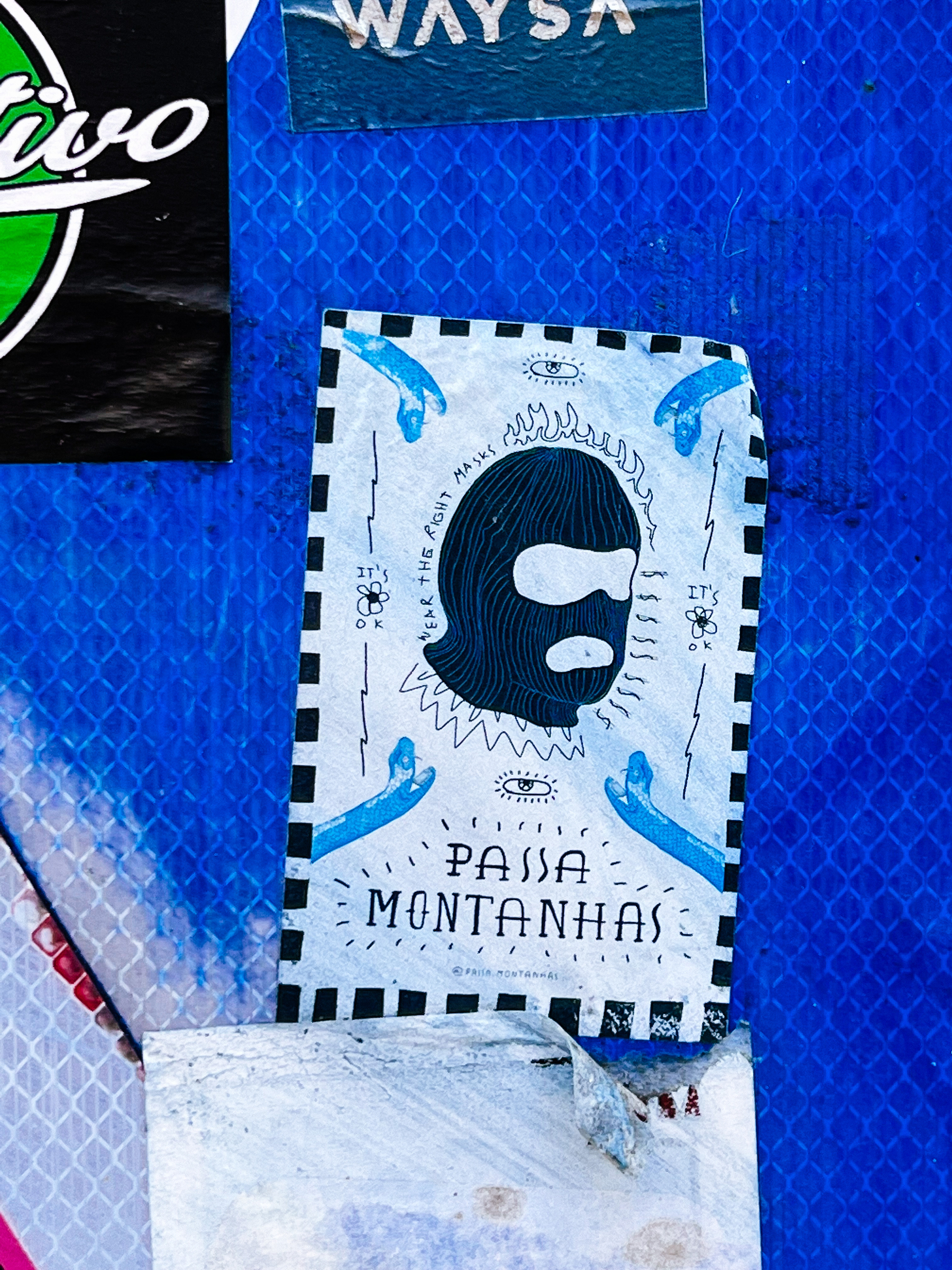 Sticker with a balaclava, and the words “wear the right masks”, along with “passa montanha”, the Portuguese words for balaclava. 