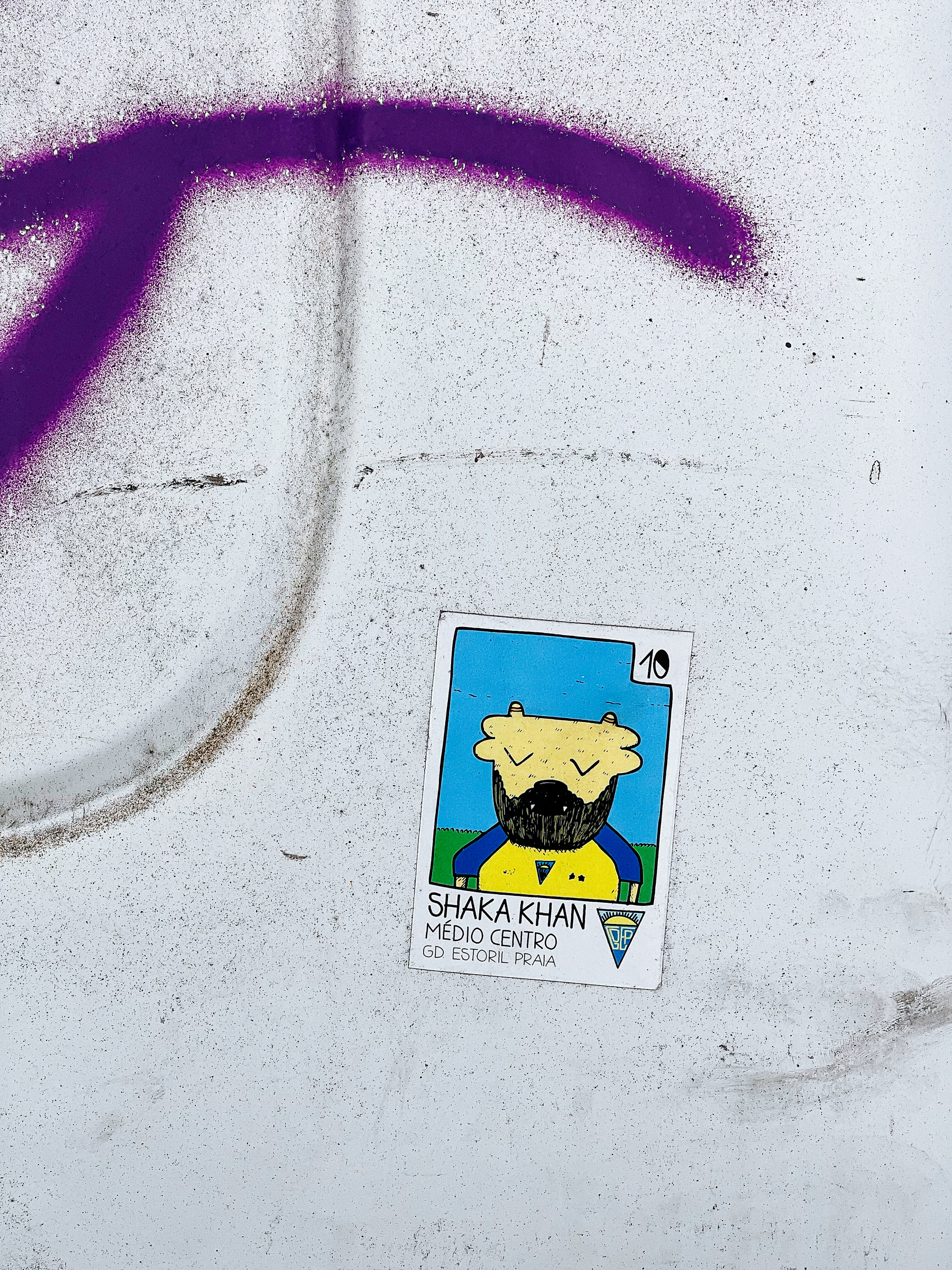 Sticker mimicking a football card, for “Shaka Khan”, from Estoril Praia, made in cartoon style. 