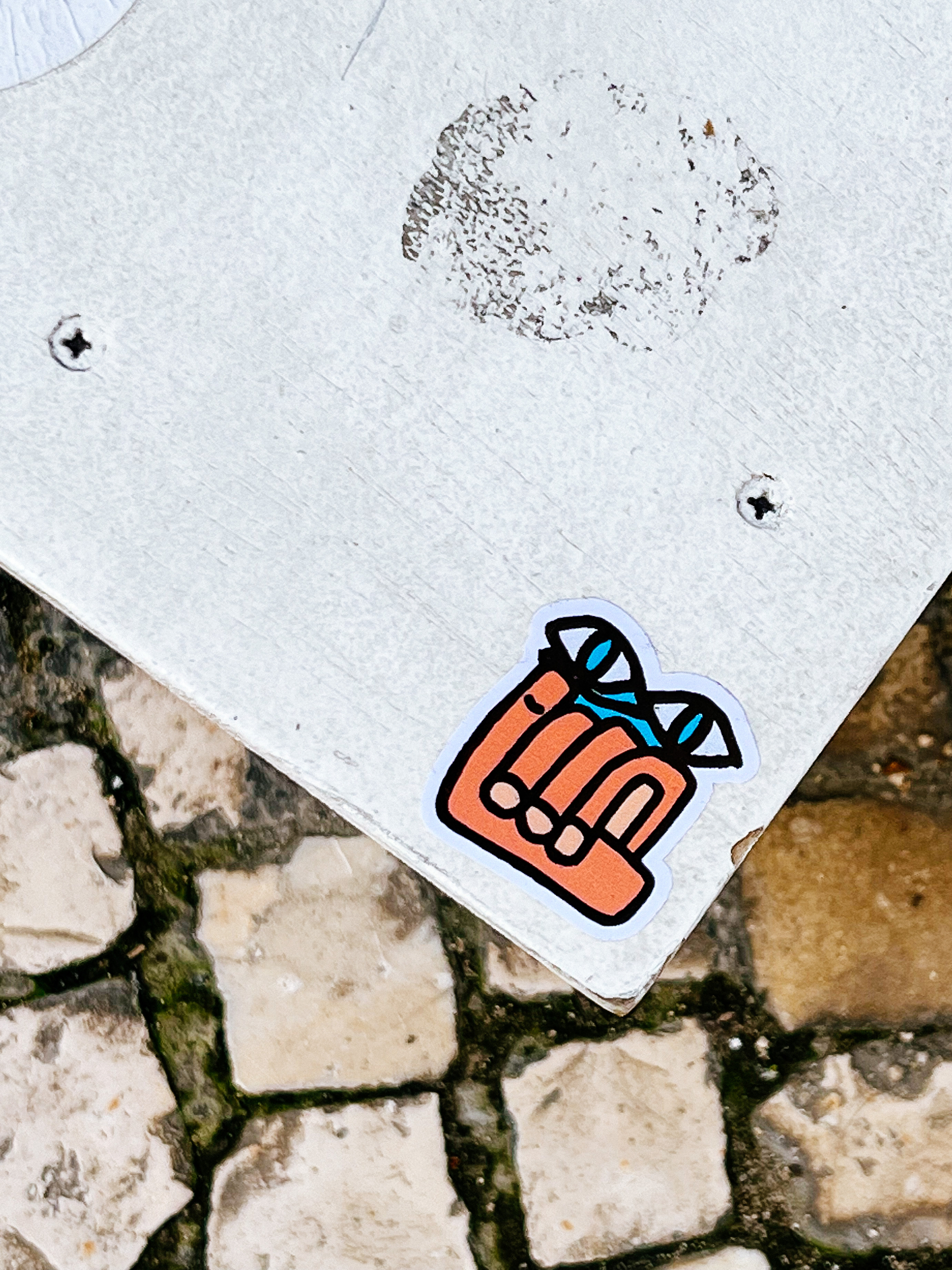 #stickerArt A sticker with a drawing of a hand, and two eyes above that. 