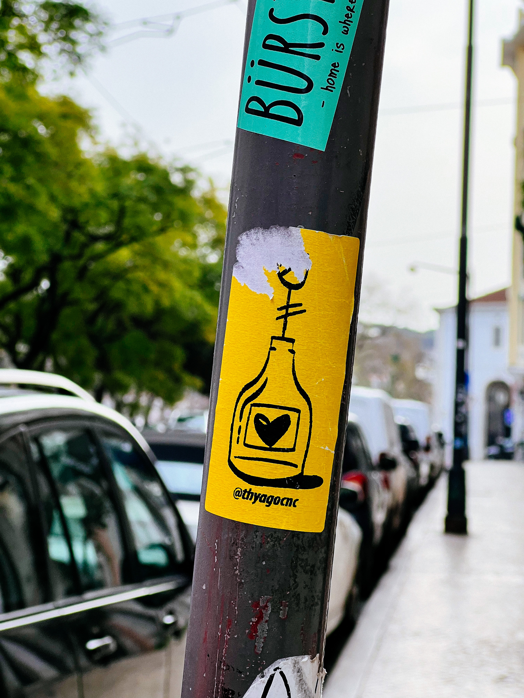 Yellow sticker with a bottle drawing, with a heart inside. 