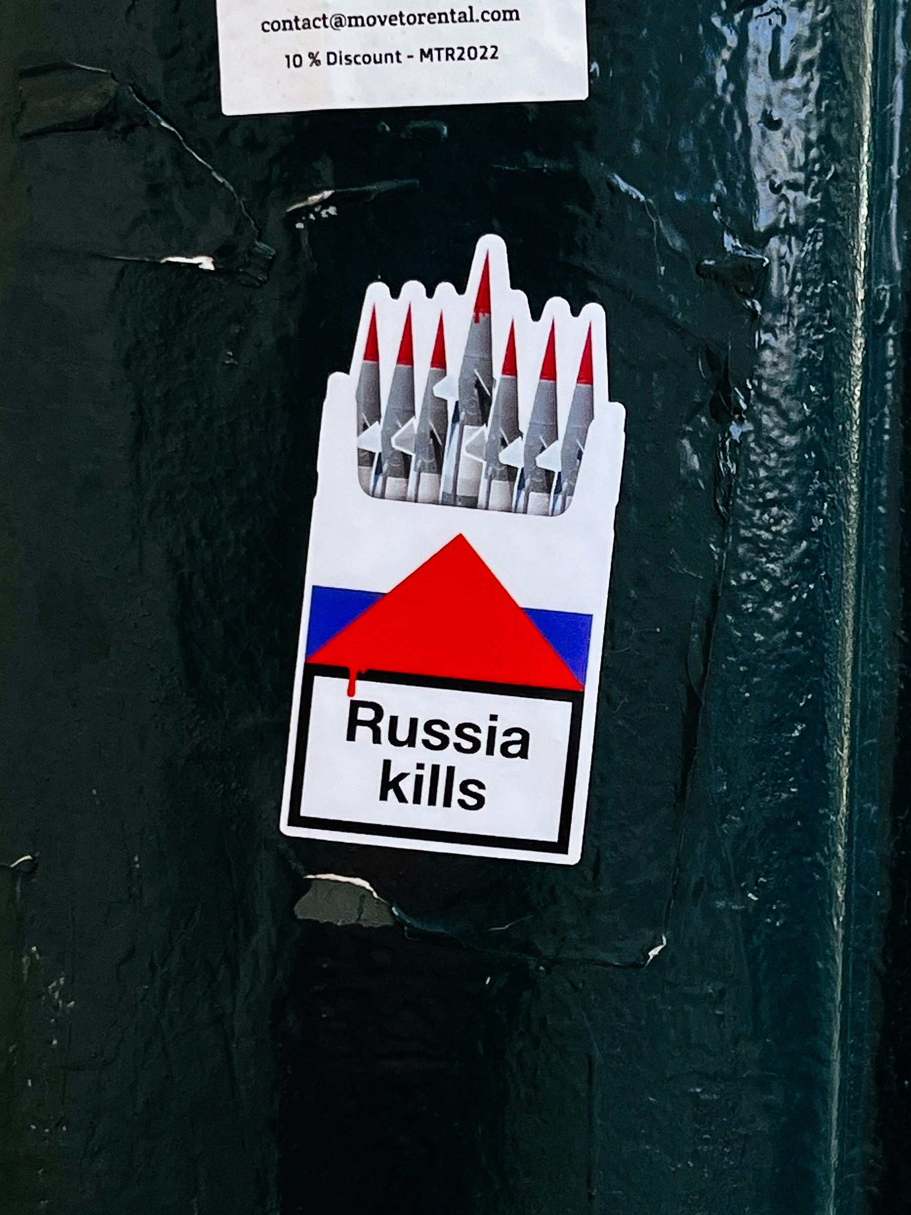 Sticker with a fake pack of cigarettes, with missiles coming out the top instead of cigarettes, and the words “Russia Kills” in the place of the health warning message. 