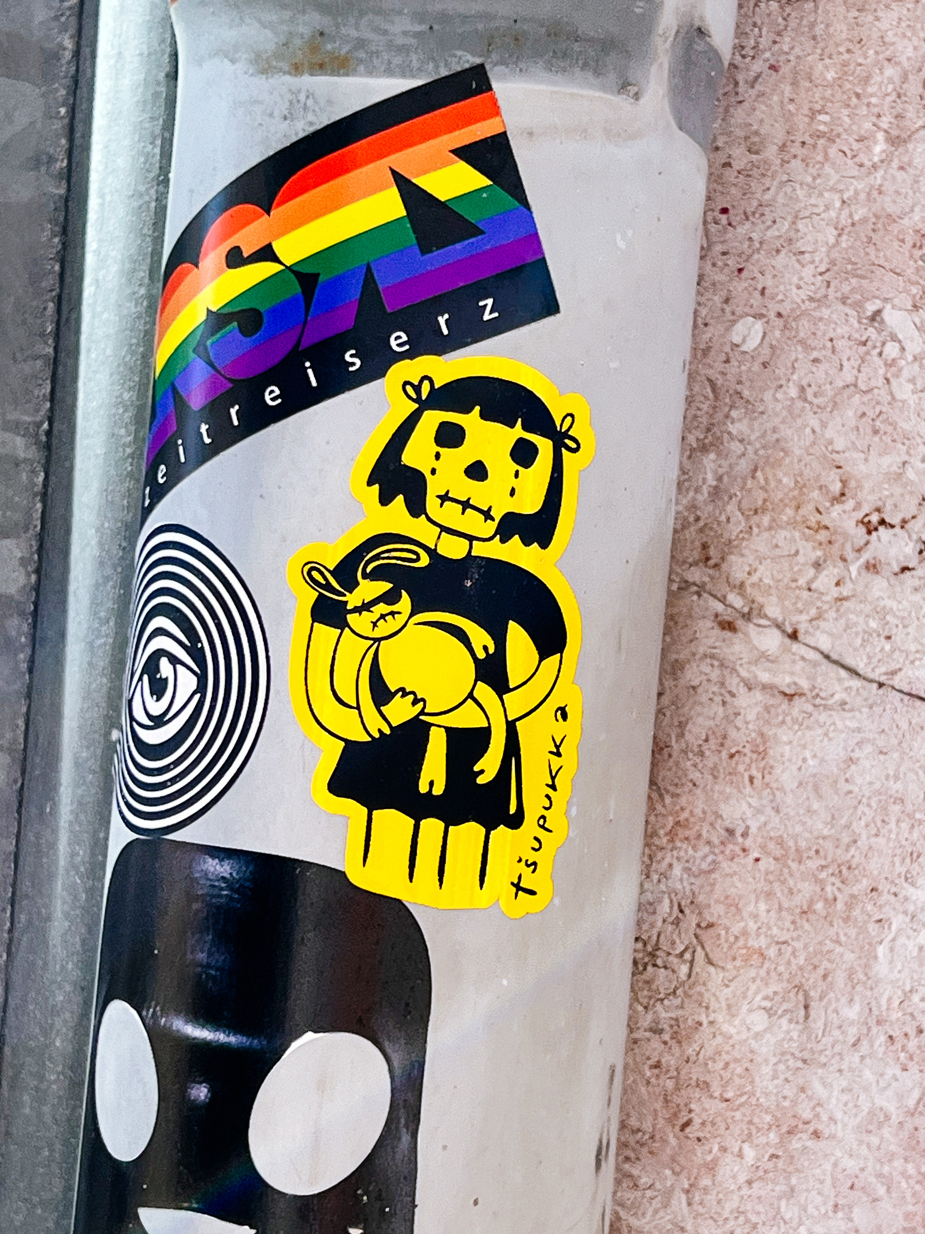 A girl with a skull as face, holding a bunny with an eye patch. Sticker. 