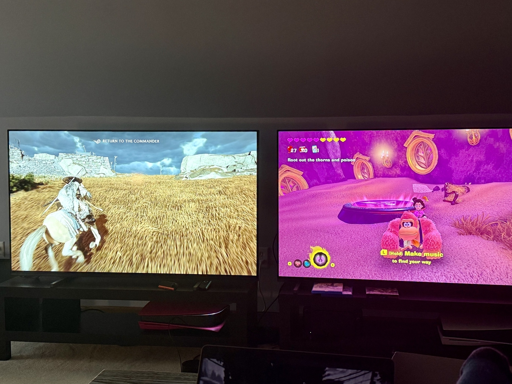 Two TVs one with pretty samurai game and one with silly monkey game 