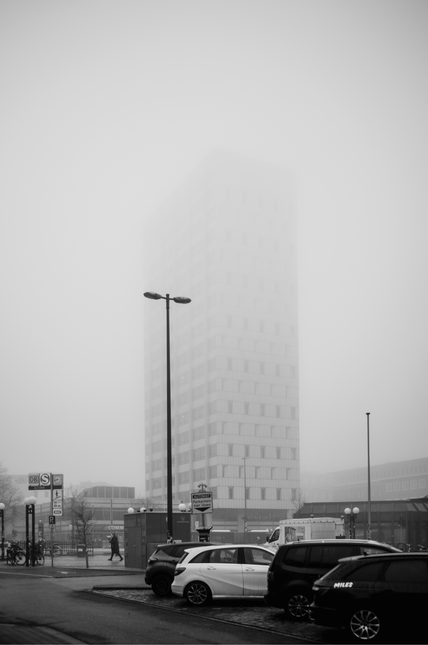 a skyscraper partly visible in the mist