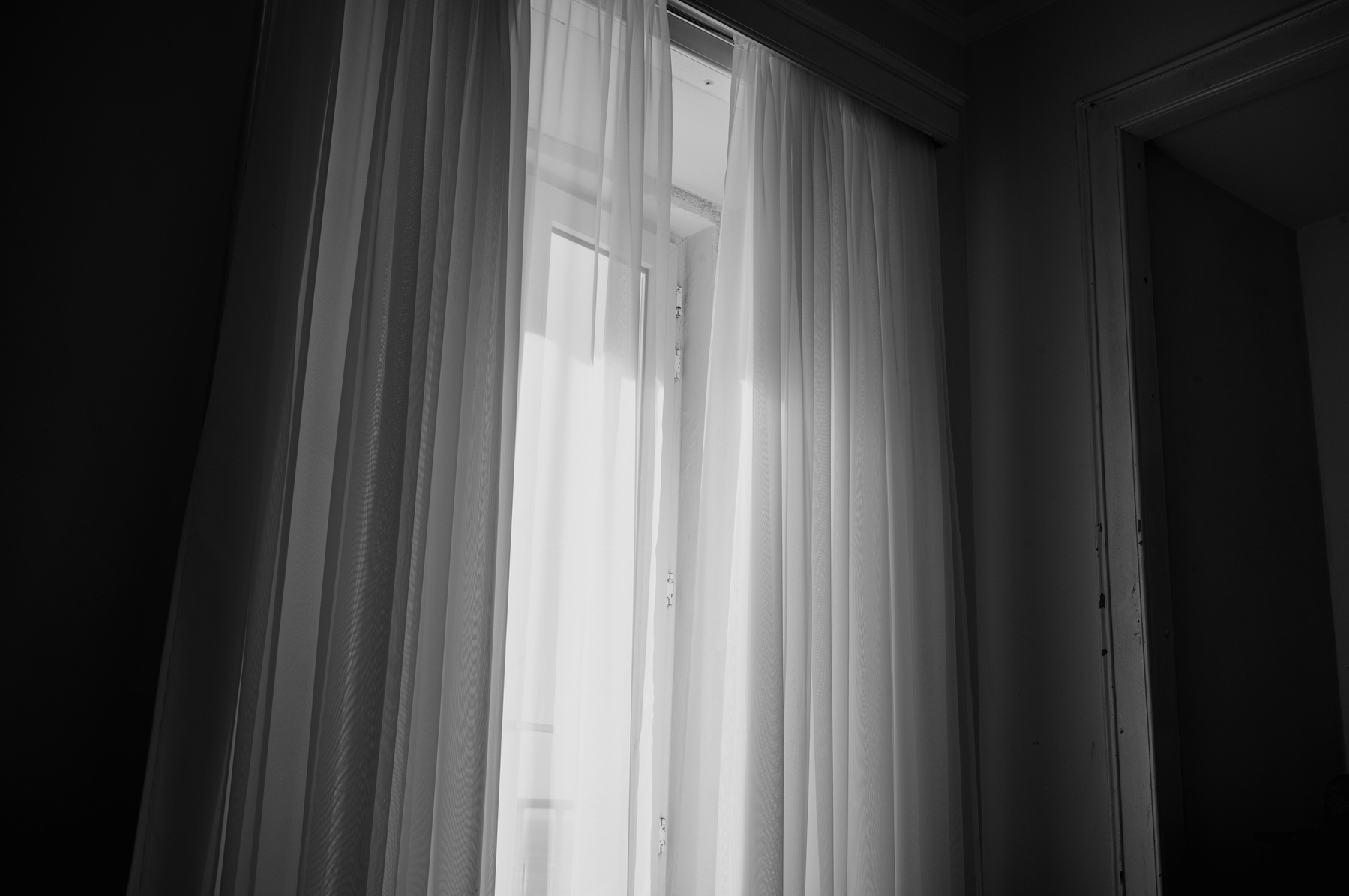 A window with curtains in black and white