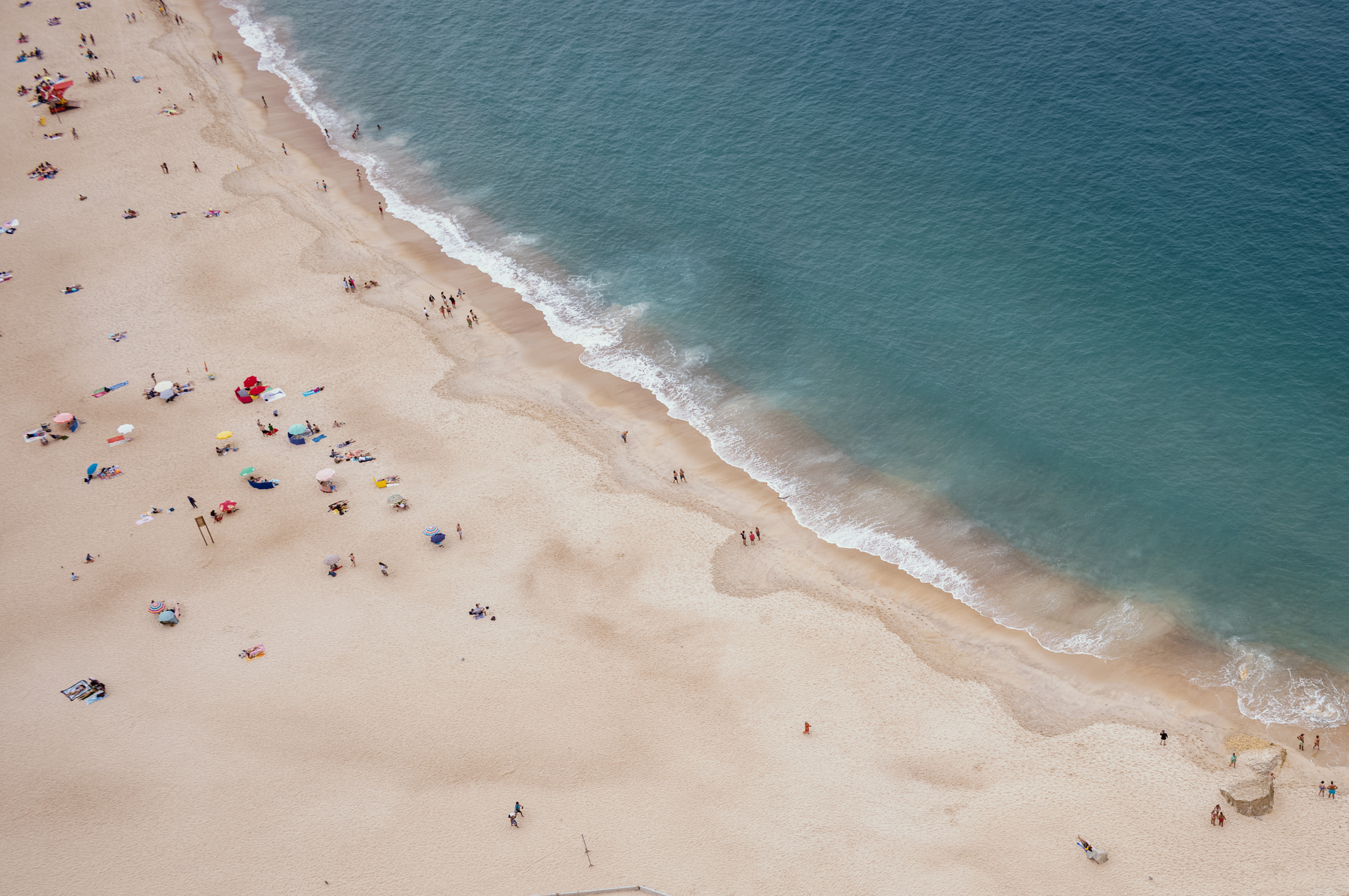 People on a beach, photographed from the top