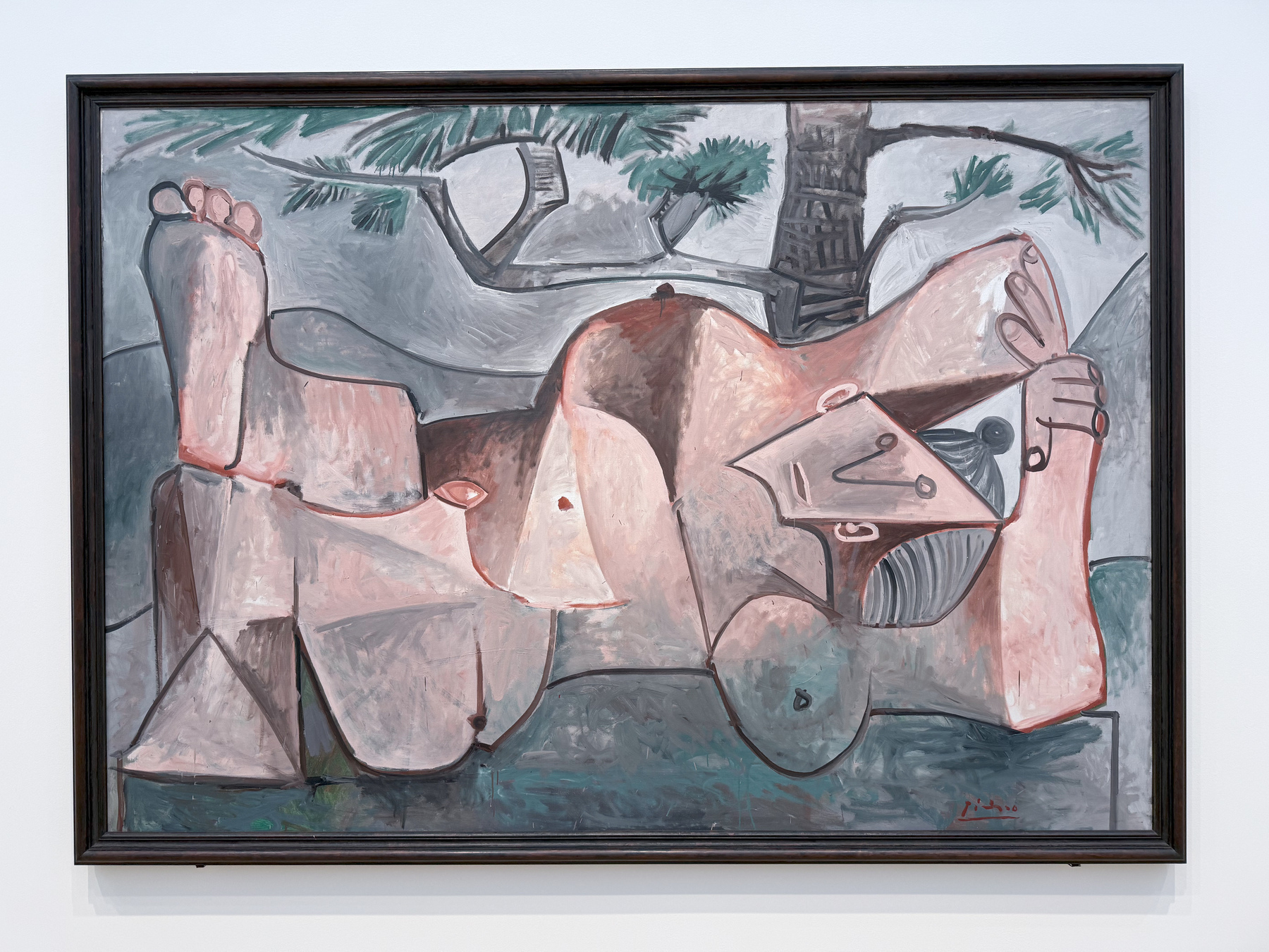 Auto-generated description: A cubist painting depicts a reclining nude figure with abstract geometric shapes and muted colors.