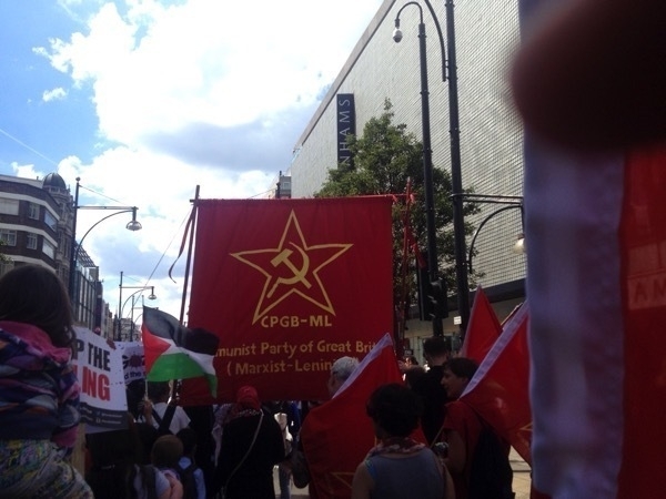 March with banner showing 'CPGB-ML Communist Pary of Great Britain (Marxist-Leninist)'
