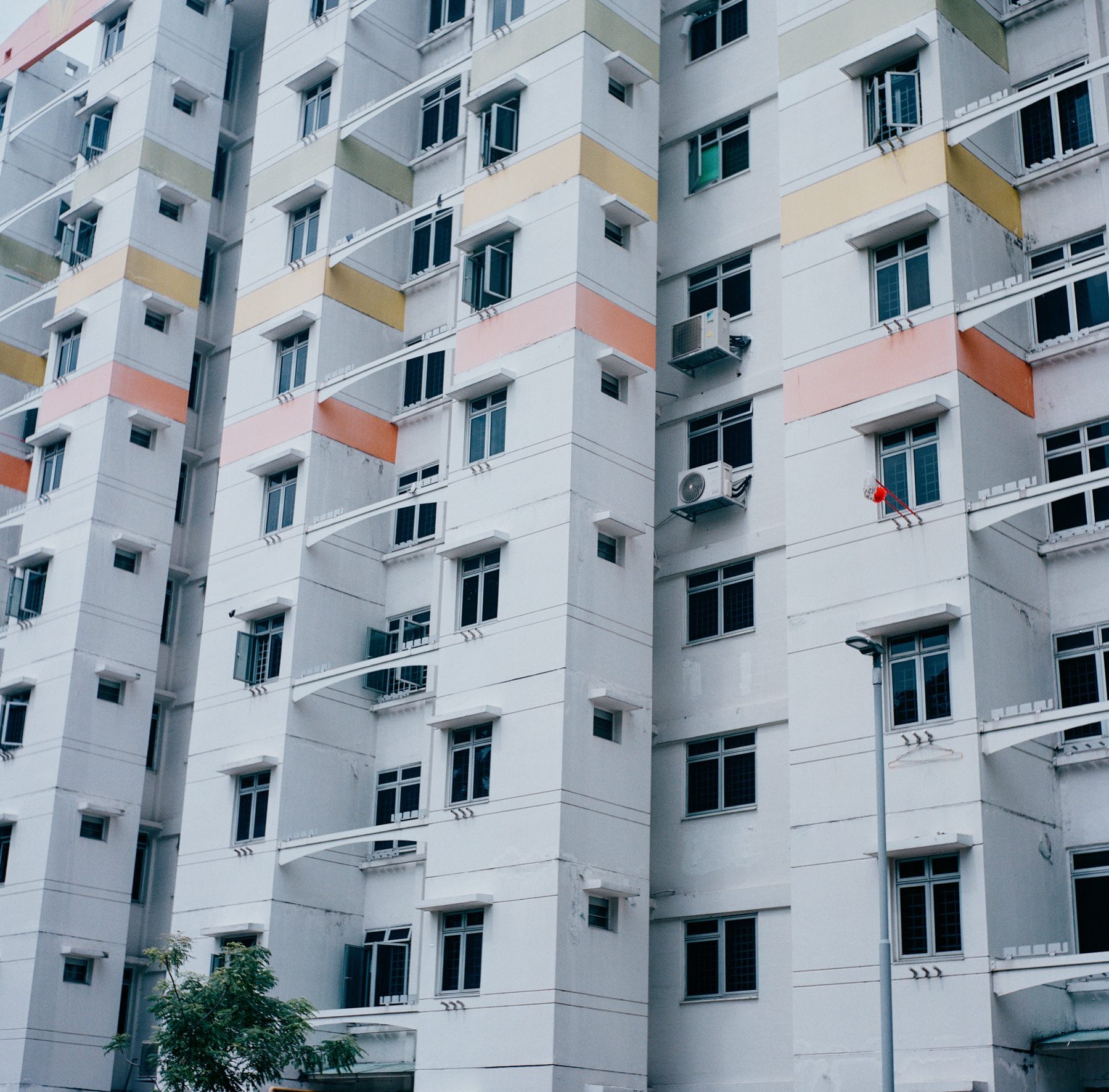 2. A scan of a color photo of a public housing estate with uniform windows in singapore