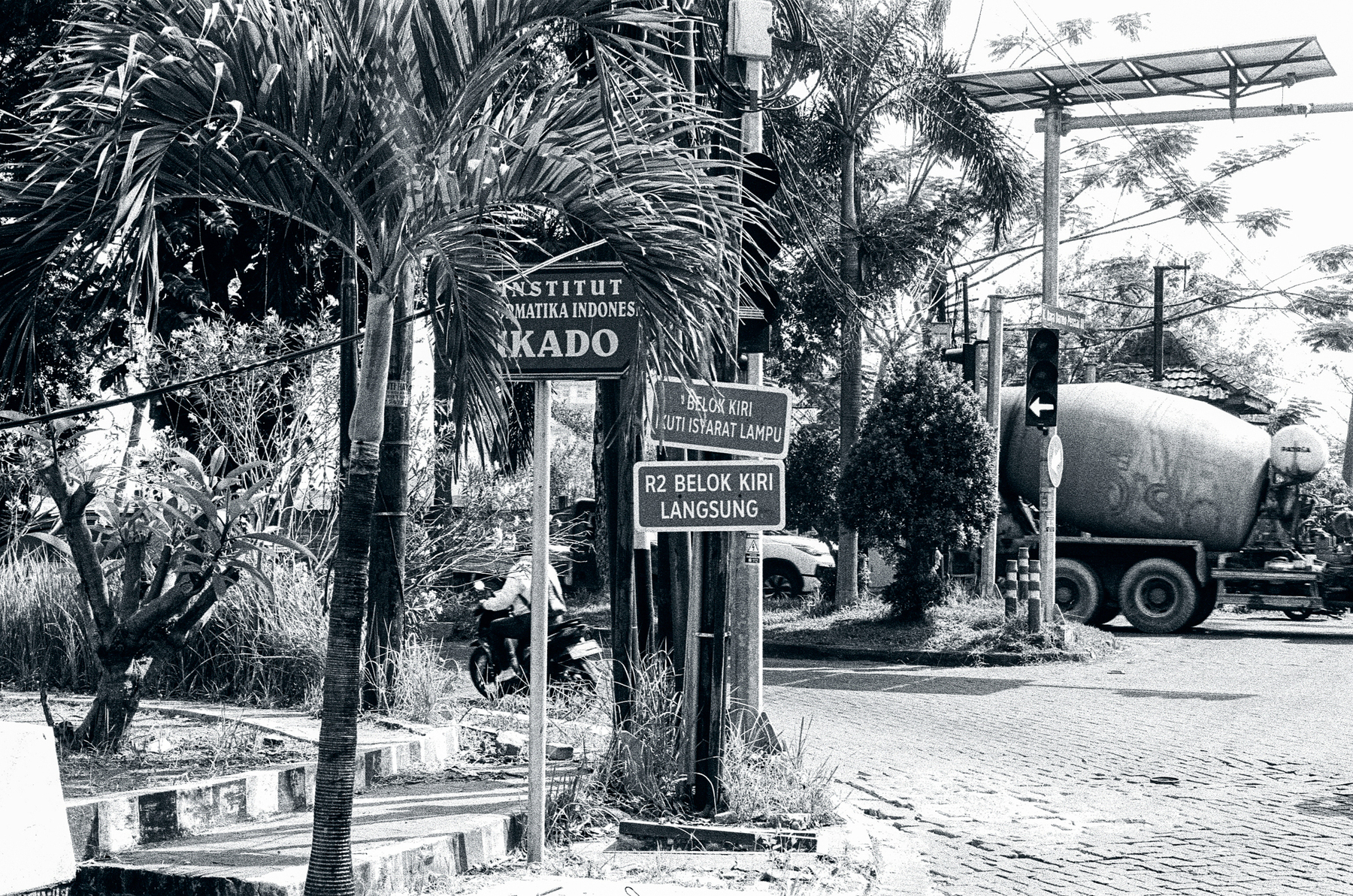 a scan of a black and white photo of street signs in surabaya