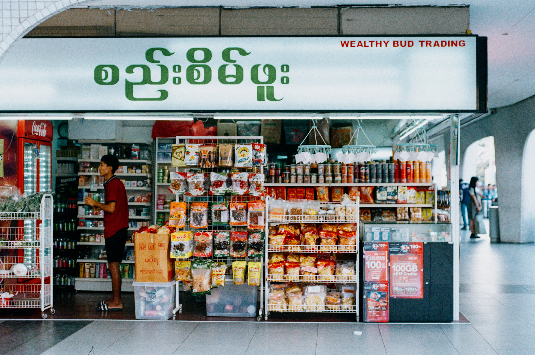 1. A scan of a color photo of a Burmese grocer in Singapore 
