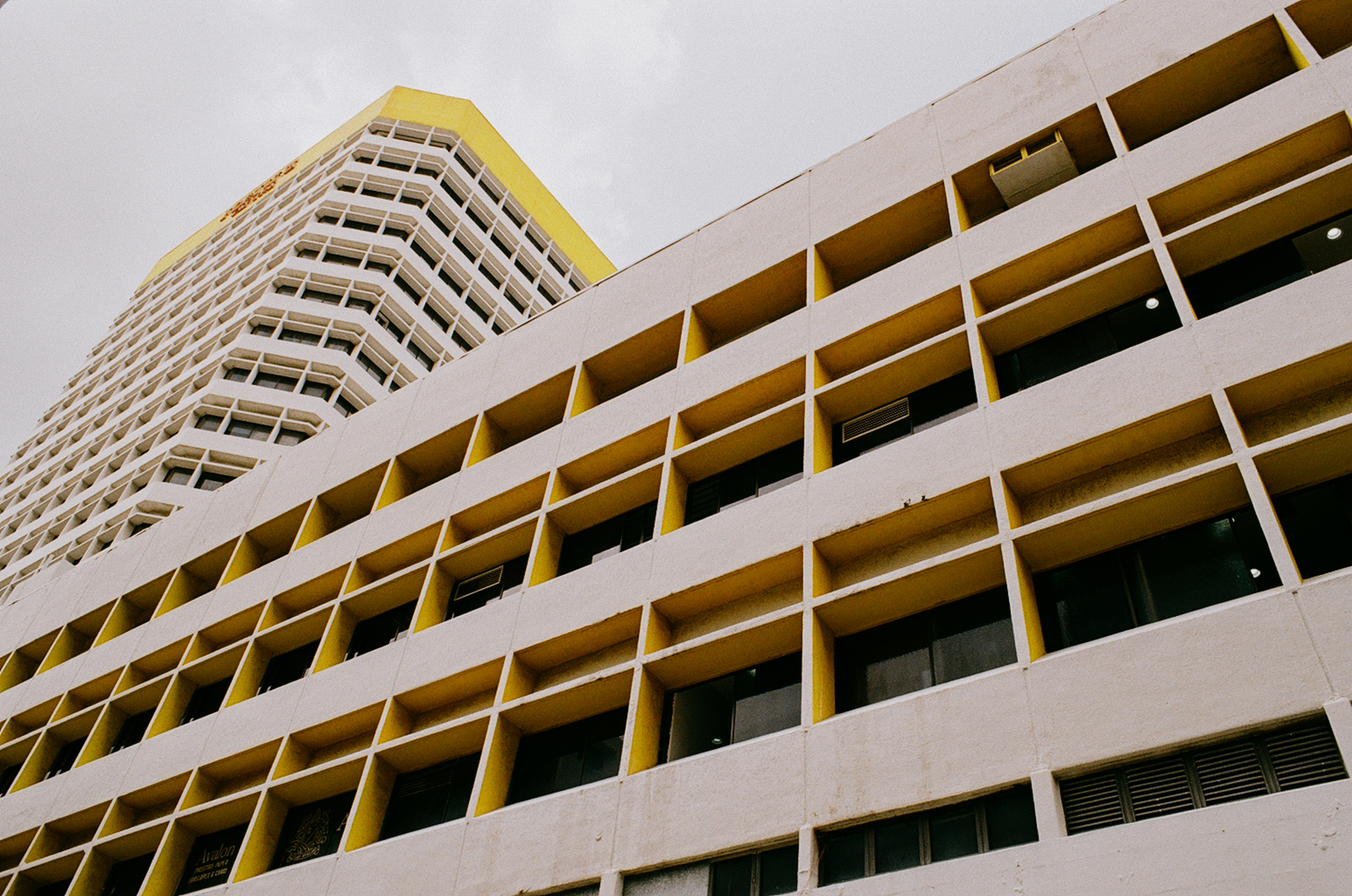 a scan of a color photo showing a geometric office building juxtaposed against another one