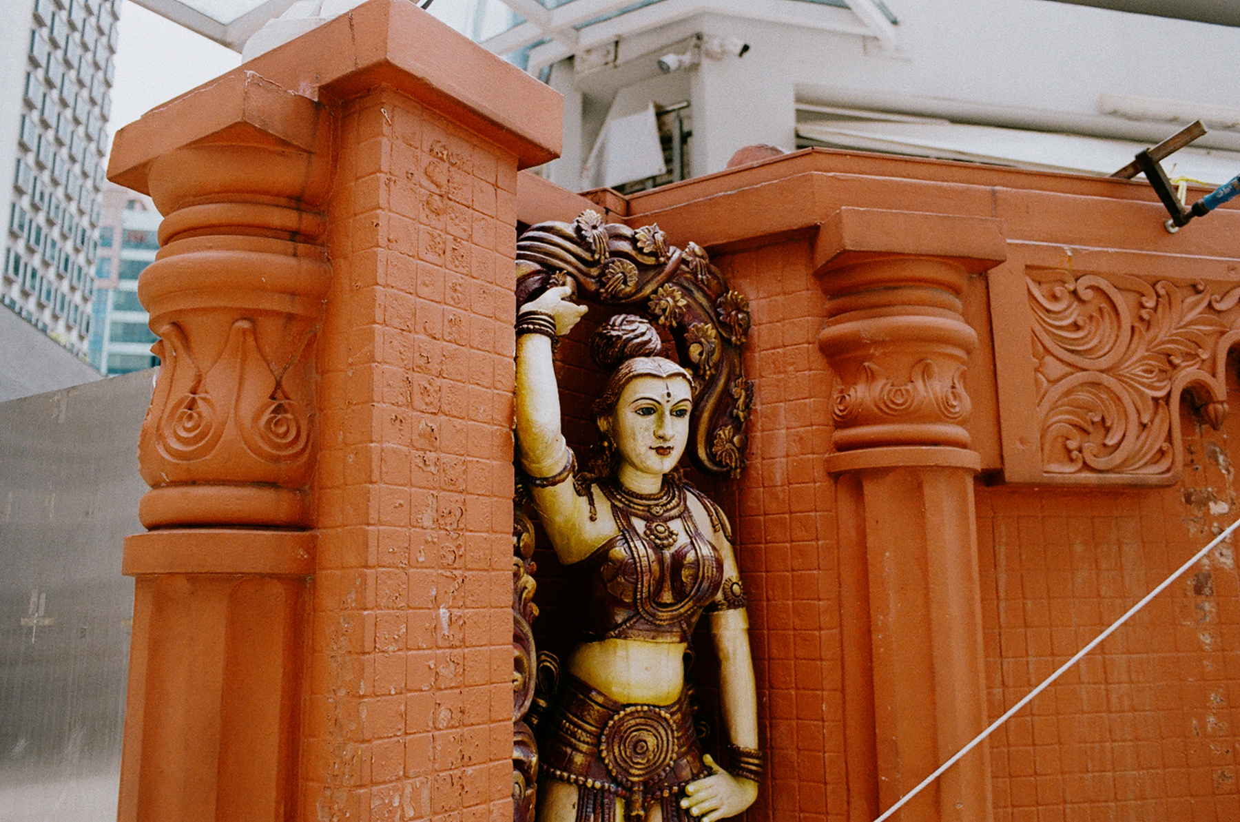 a scan of a color photo showing a carving of a Hindu deity on the side of the Sri Krishnan temple