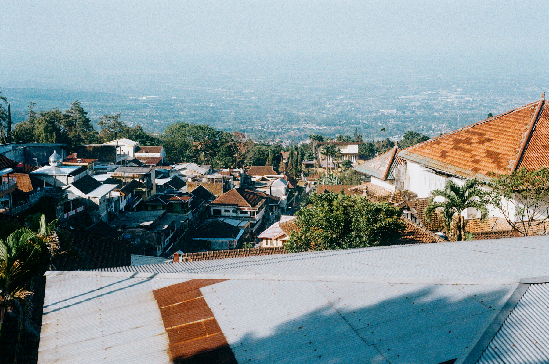 a scan of a color photo of a valley in East Java from the top of a building