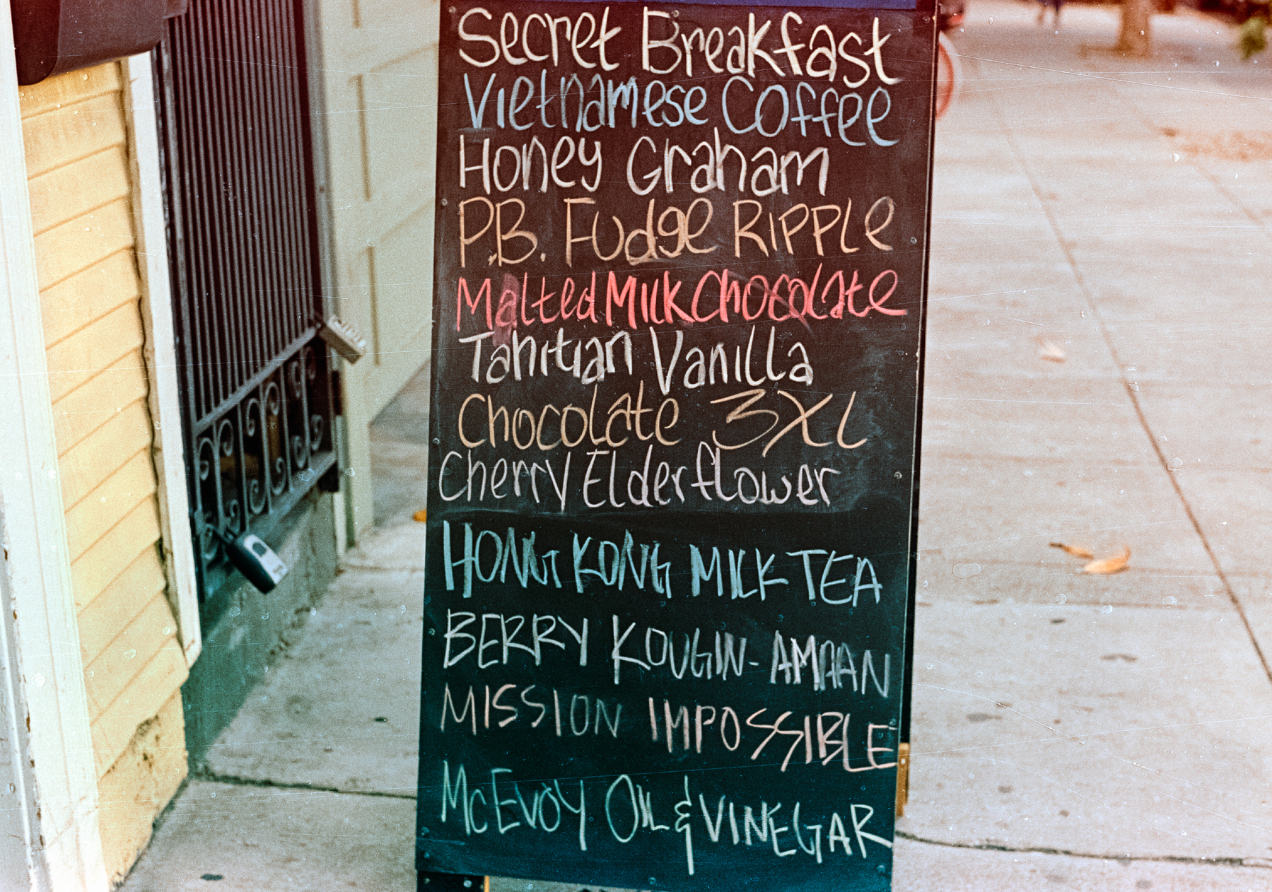 a scan of a color photo of ice cream flavors on a chalkboard in the Mission, with interesting flavors like vietnamese coffee and hong kong milk tea