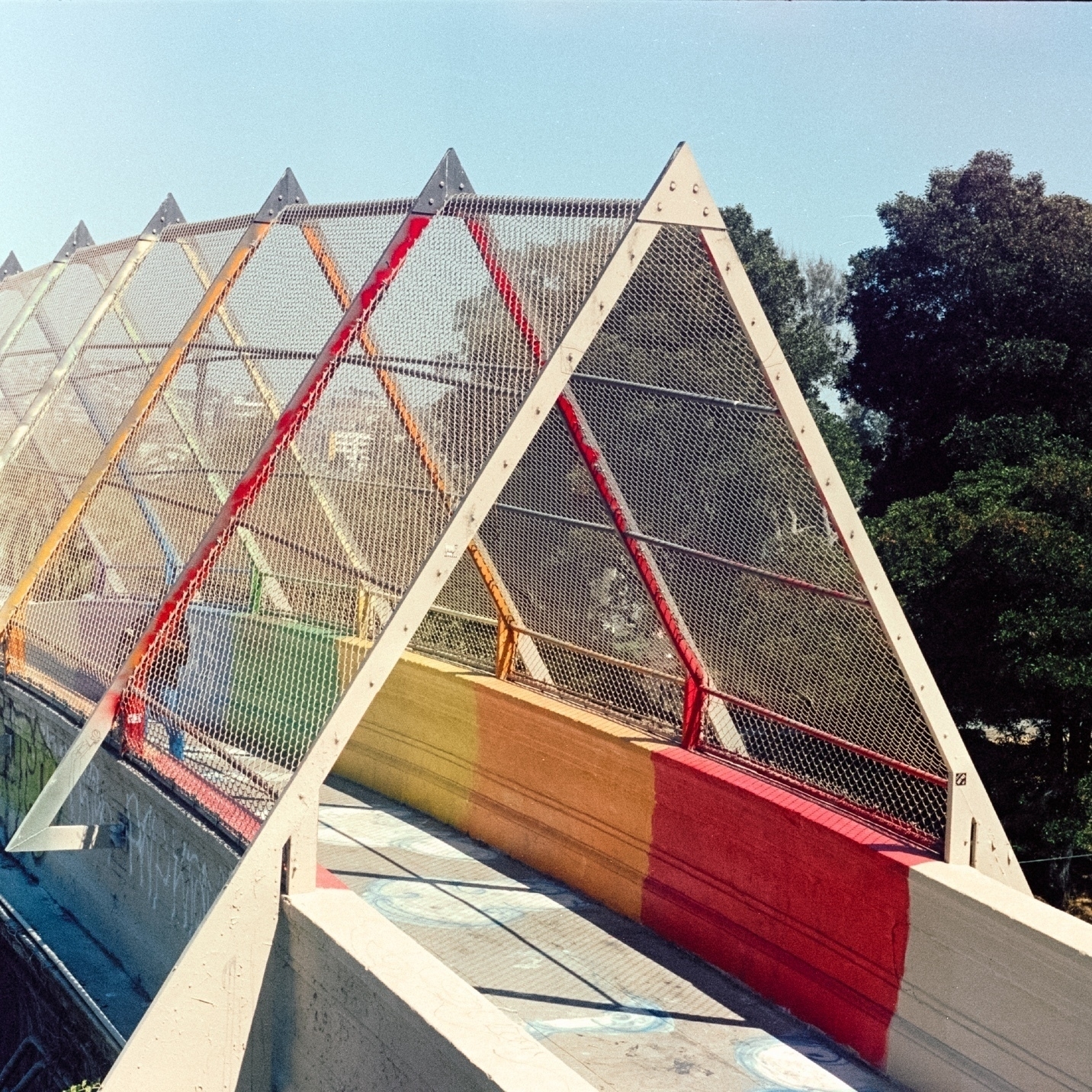 a scan of a color photo of a colorful bridge in the Castro in San Francisco in a cropped square format