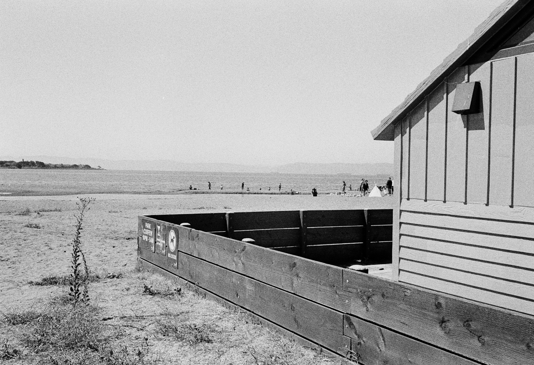a scan of a black and white photo showing a beach hut on a beach in Alameda, California