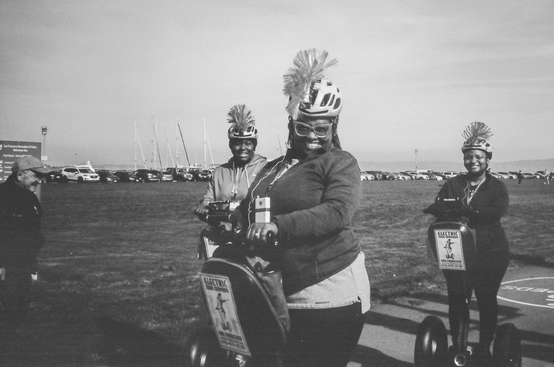 a black and white photo of some women traveling by Segway along Crissy Fields in San Francisco