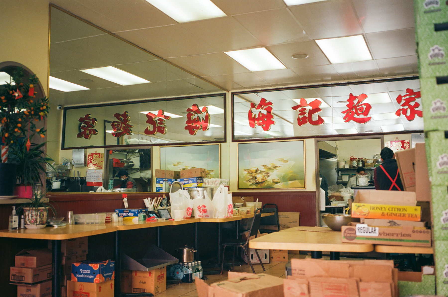 a color photograph of the insides of a Vietnamese Chinese restaurant in San Francisco, with Chinese words on the banner