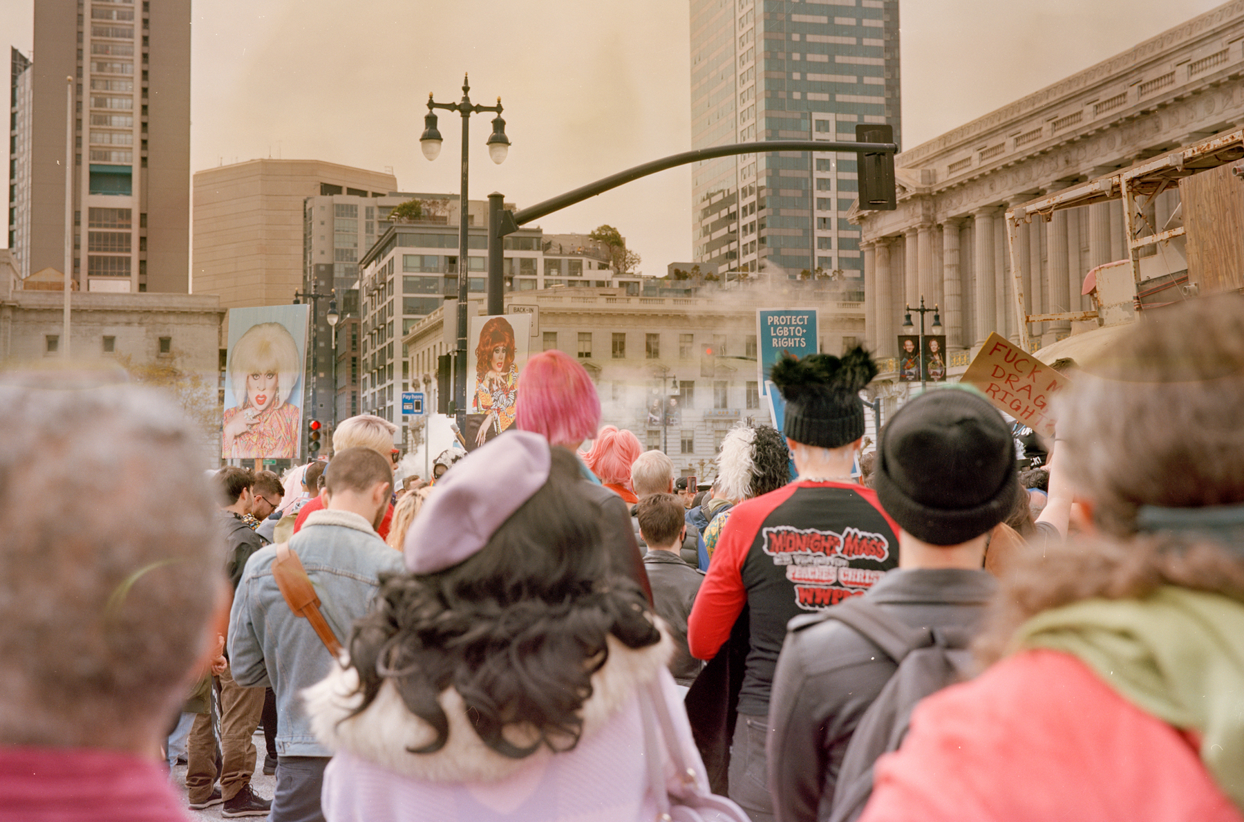 a scan of a color photo showing people marching together at a trans rally