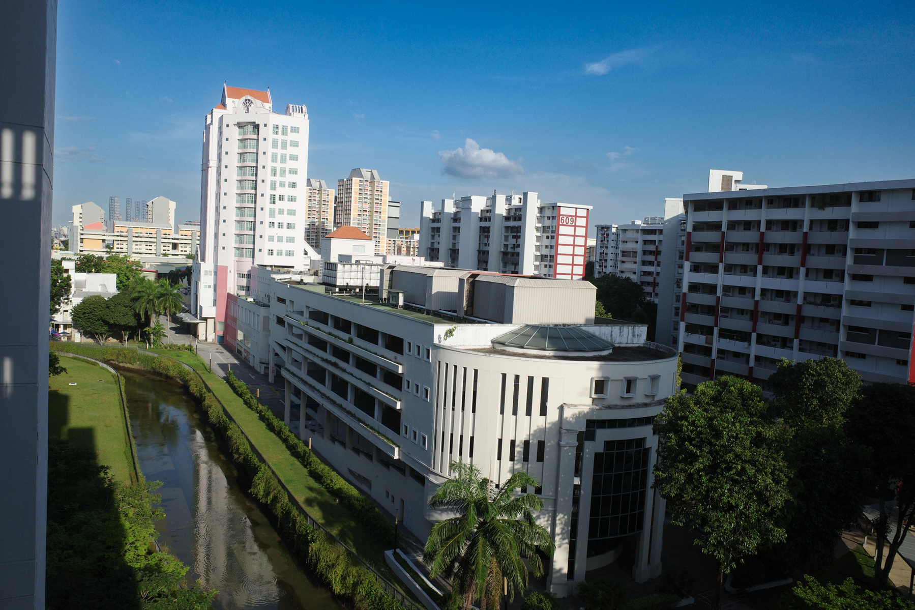 a color photograph of a view of a Singapore mall next to a canal and tall buildings around it