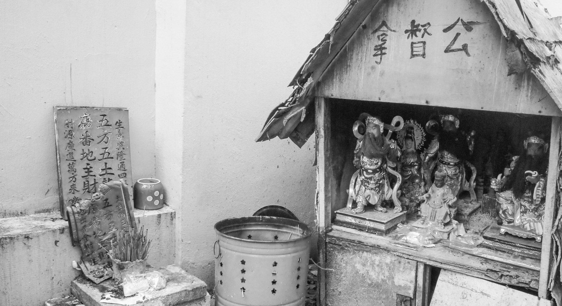 A black and white photo of an altar of Chinese gods