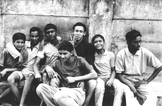 A black and white photo of a group of boys in Kolkata, India