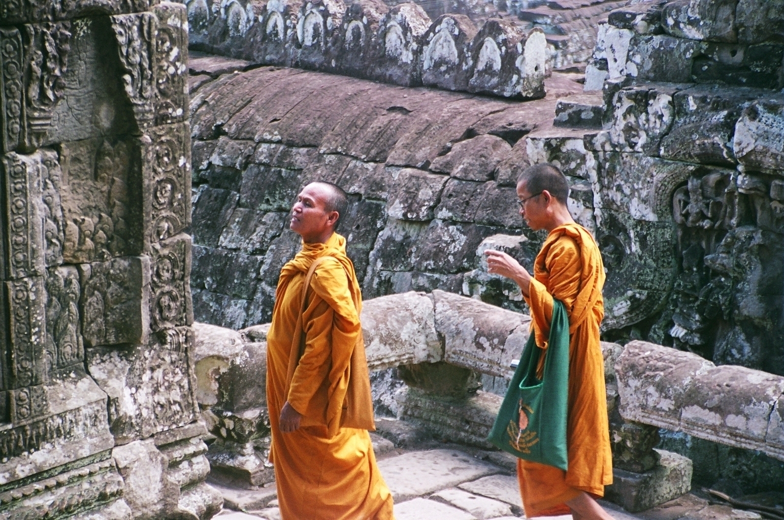 a scan of a color photo of monks at Angkor Wat in Cambodia smiling at a structure