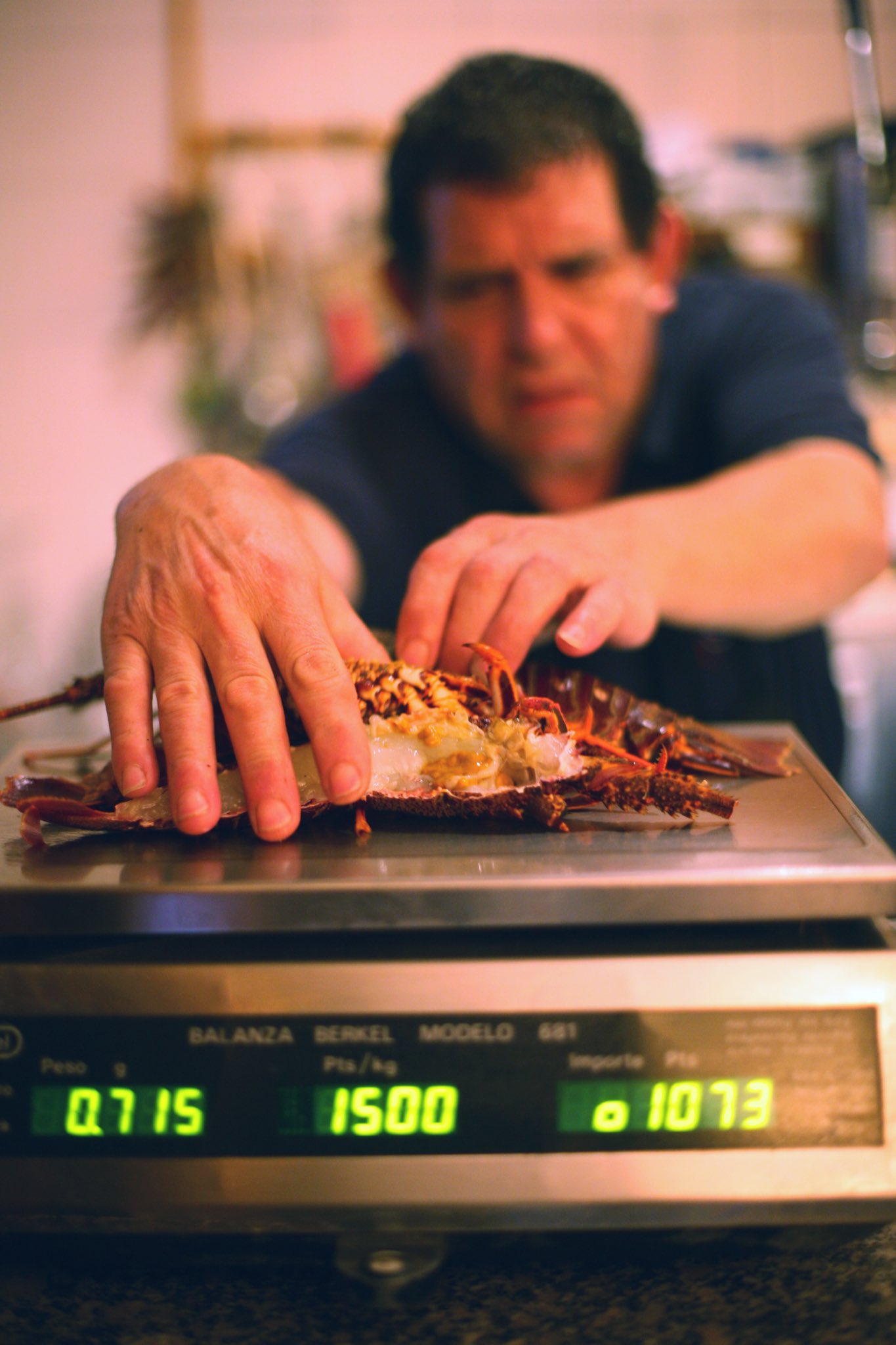A fishmonger weighing seafood in Spain