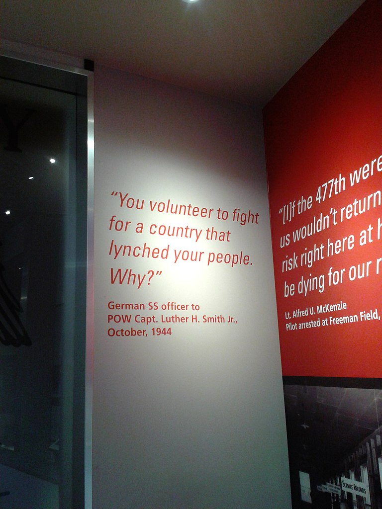 A museum display with the quote "You volunteer to fight for a country that lynched your people. Why?" from an SS officer to an American Black POW, CPT Luther H. Smith, Jr.
