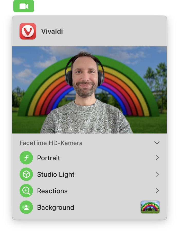 A person wearing headphones is on a video call with a vibrant rainbow background and video settings options displayed.