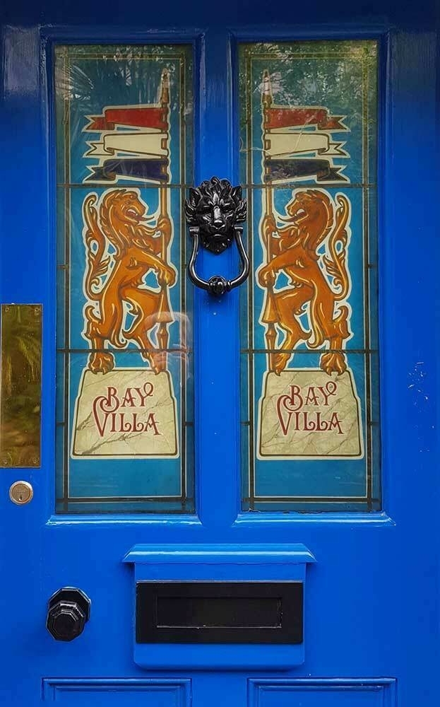 A boor, painted blue, with two decorative panels featured red rampant lions and the name Bay Villa on each