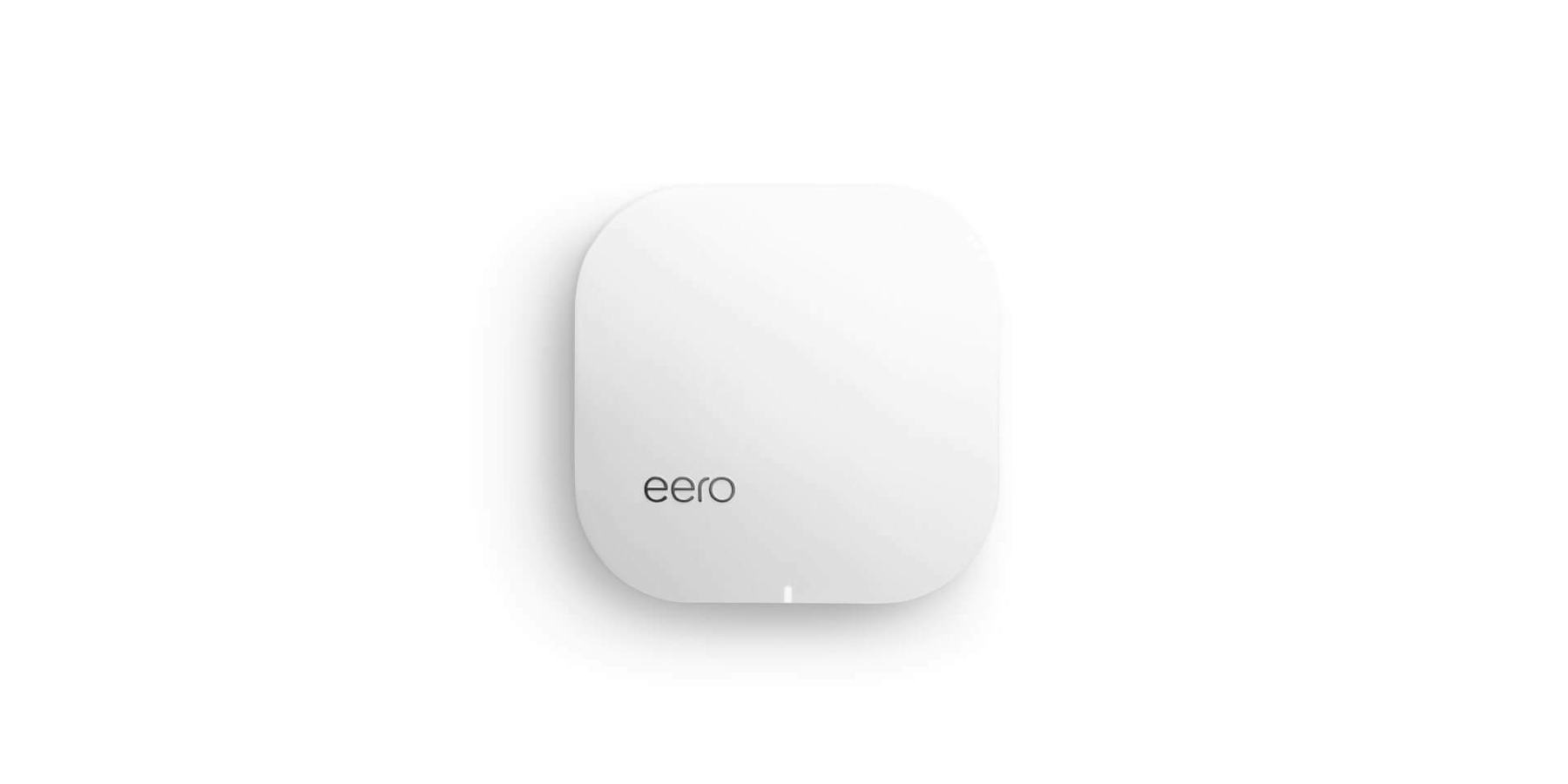 A white, square-shaped Eero Wi-Fi router with rounded edges is centered on a plain background.