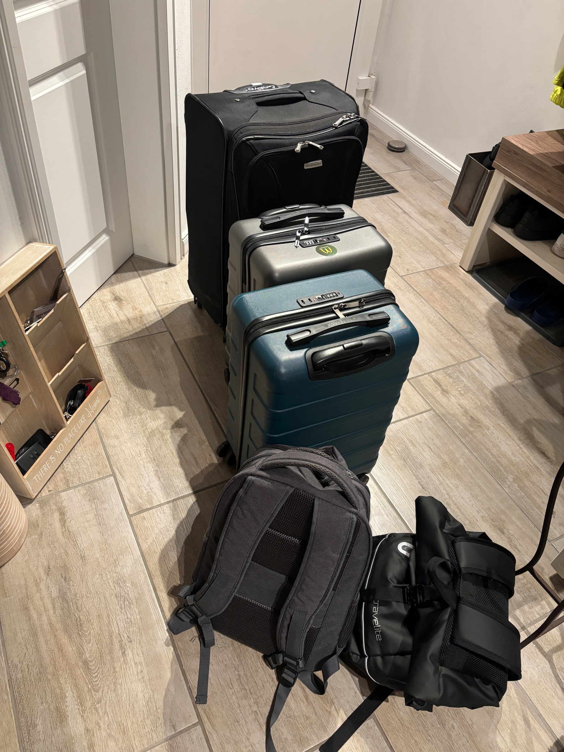 One large suitcase, two carry-on suitcases, and 2 backpacks waiting by our front door.